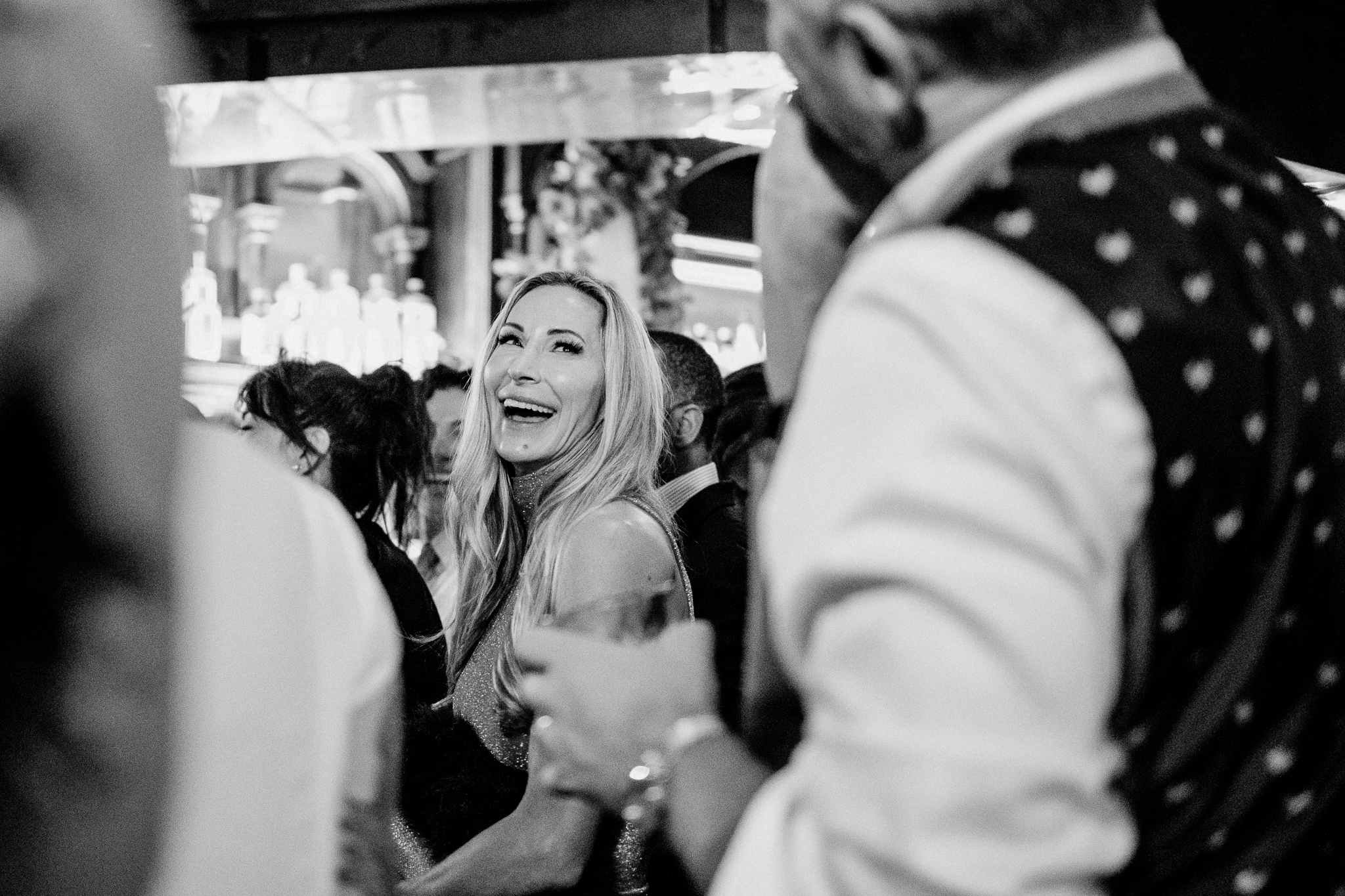 Smiling female wedding guest laughing during the wedding reception at J.R. Mahon's Dublin