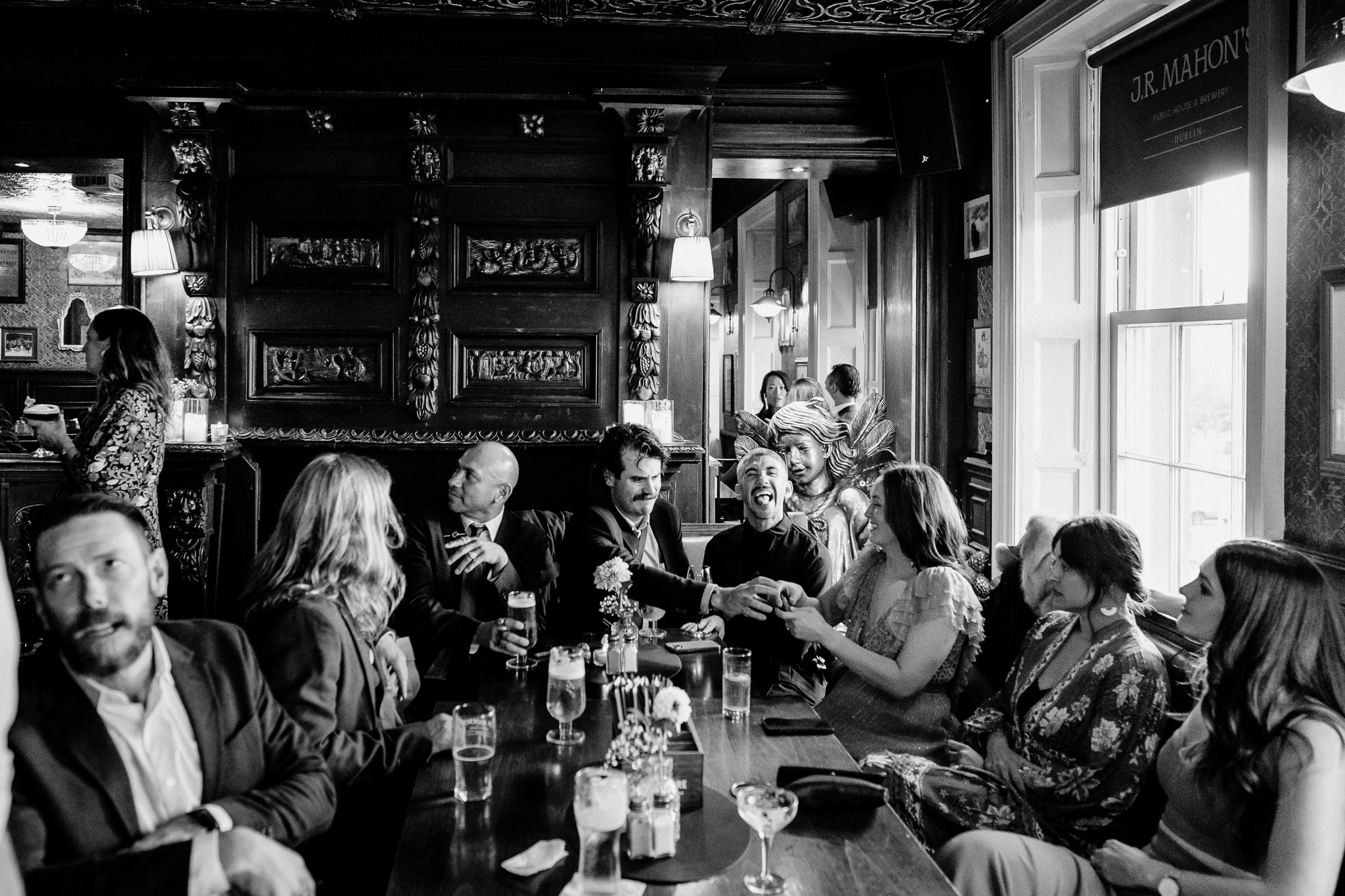 Atmospheric black and white photograph of the interior of J.R. Mahon's during a Dublin wedding reception
