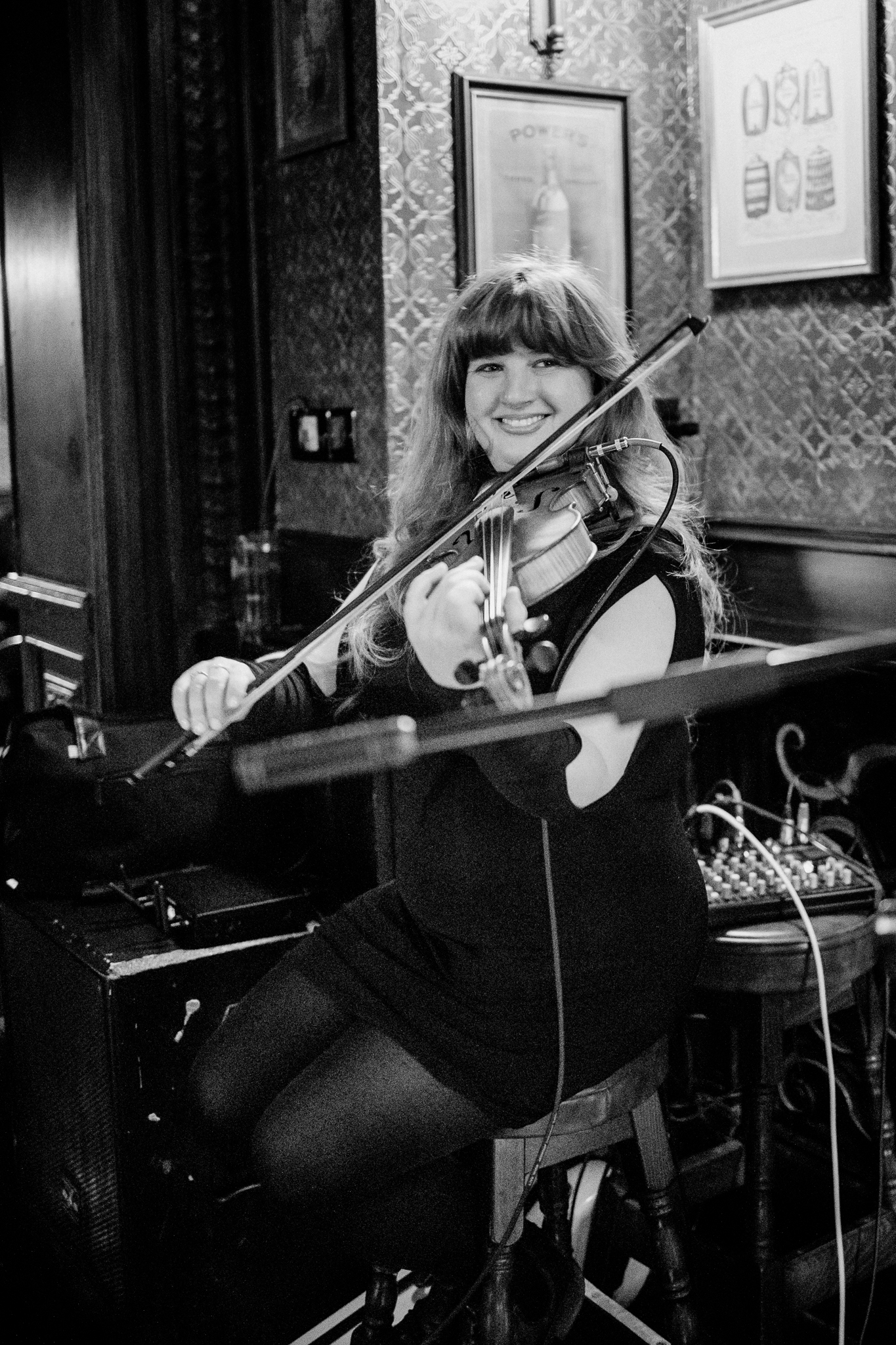 Smiling female violinist playing live music during a wedding reception at J.R. Mahon's in Dublin