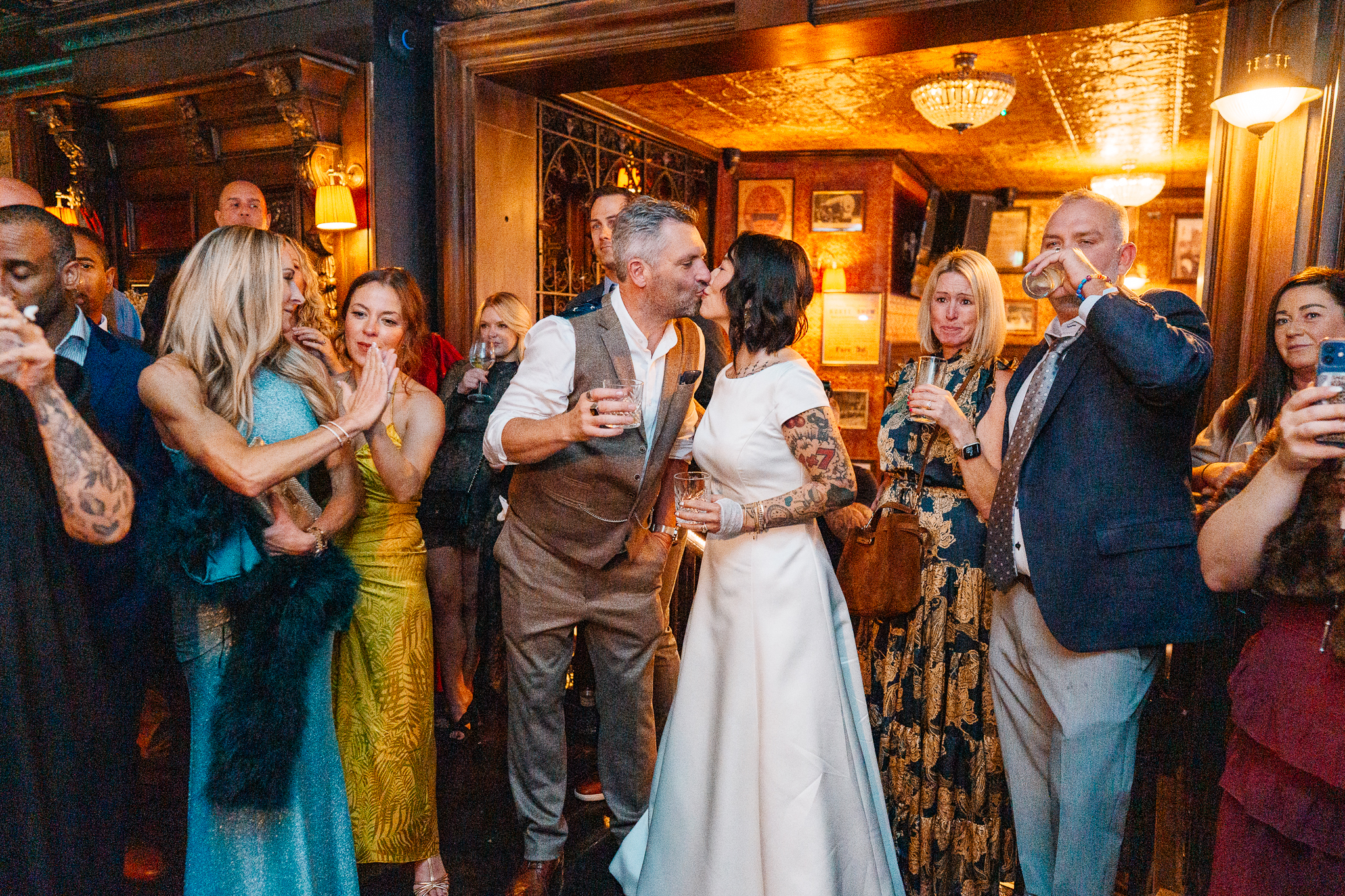Wedding guests cheering and raising their hands during a lively reception at J.R. Mahon's Dublin