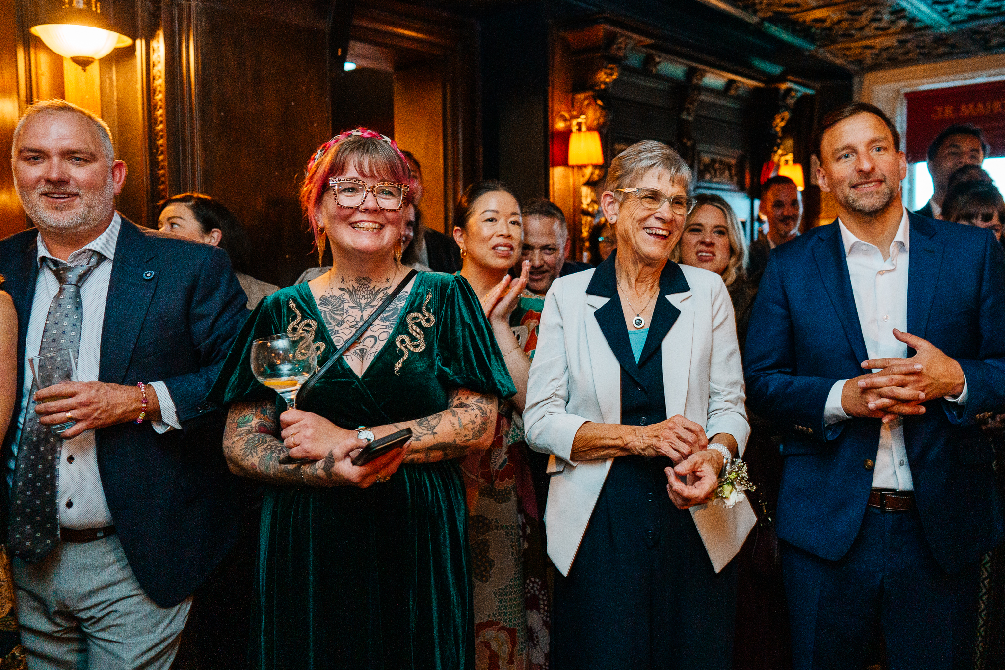 Group of smiling wedding guests enjoying the evening reception at J.R. Mahon's in Dublin