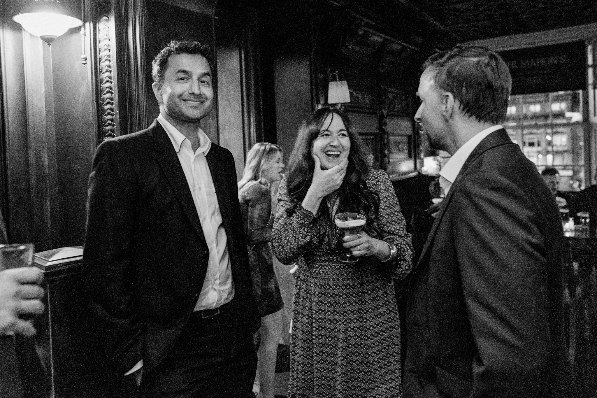 Smiling wedding guests sharing a candid moment during the reception at J.R. Mahon's Dublin