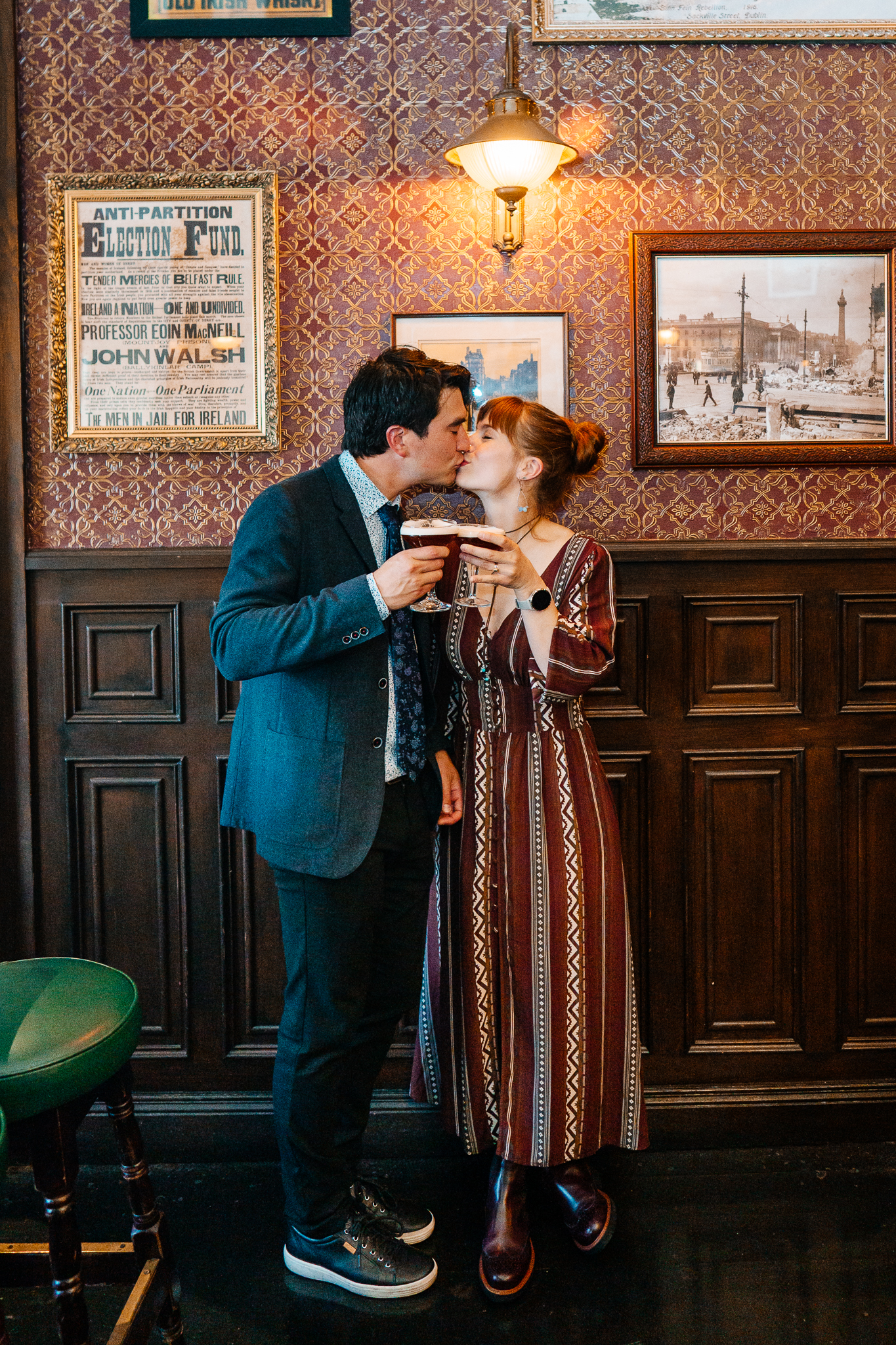 Bride and groom sharing a kiss during their wedding reception inside J.R. Mahon's pub in Dublin