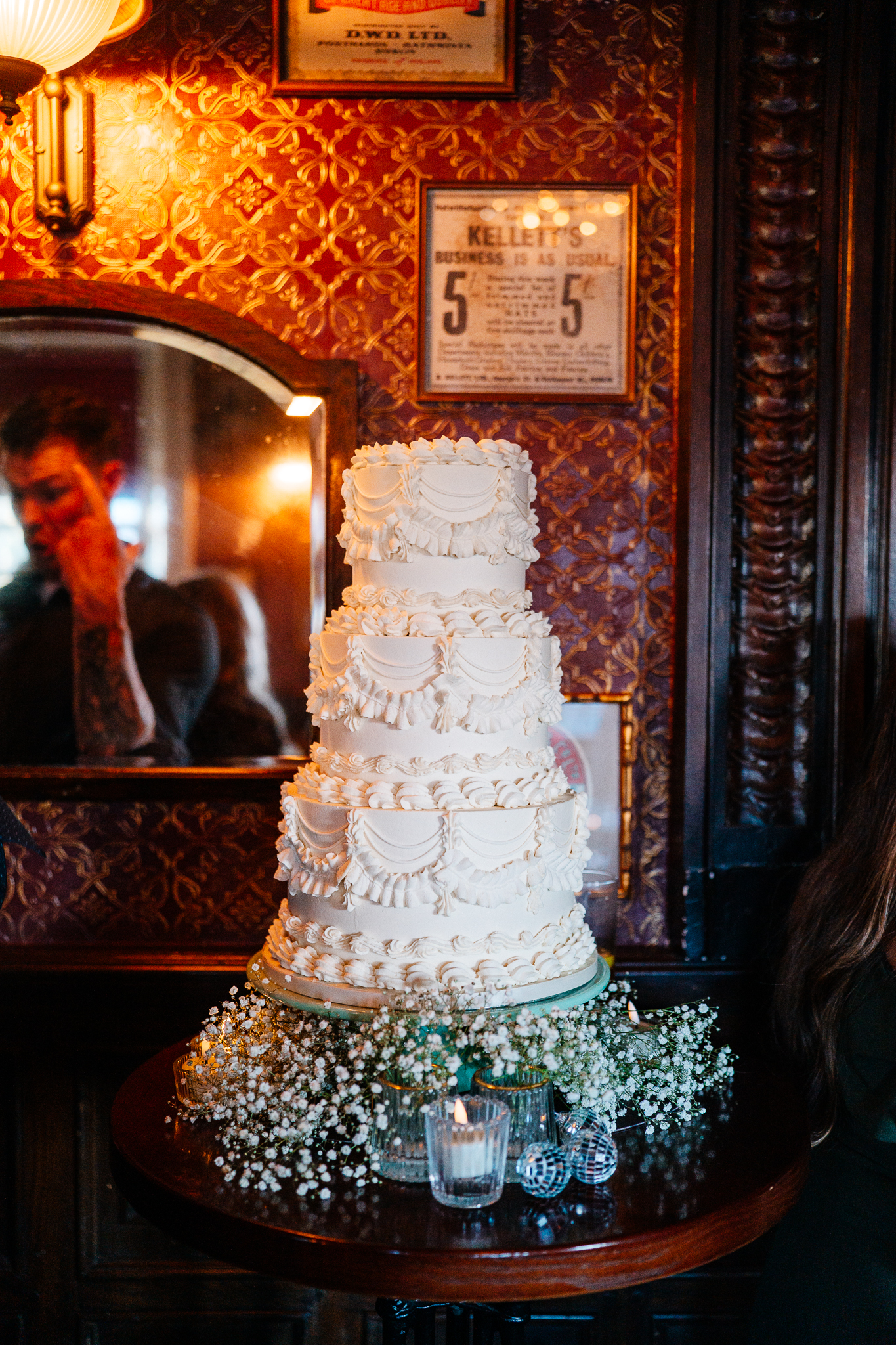Bride and groom standing close together during their wedding cake cutting at J.R. Mahon's Dublin