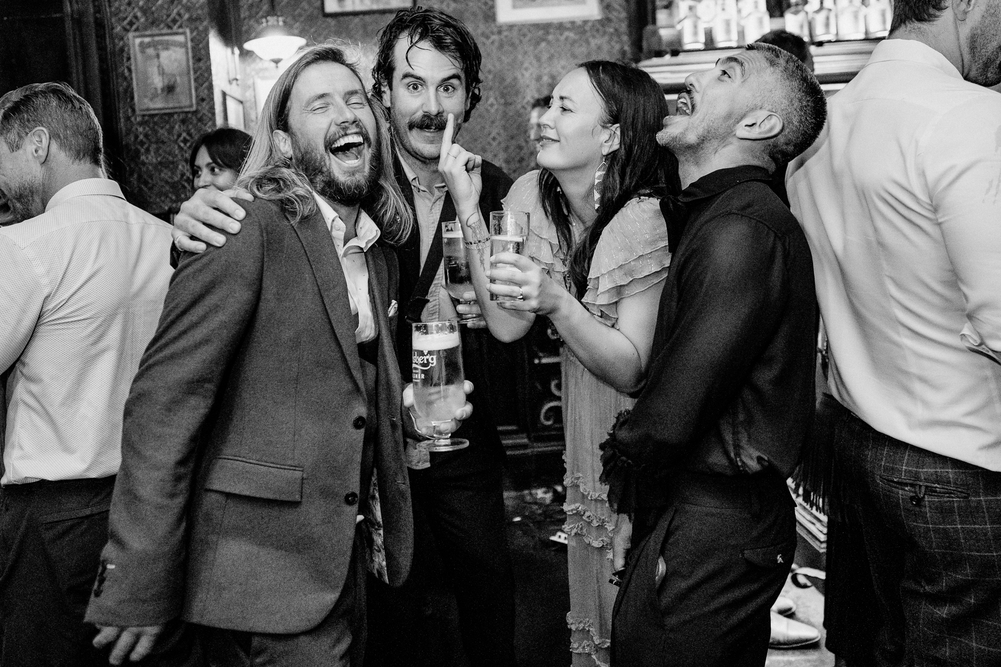 Pink and Joe celebrating with wedding guests during their cake cutting at J.R. Mahon's in Dublin