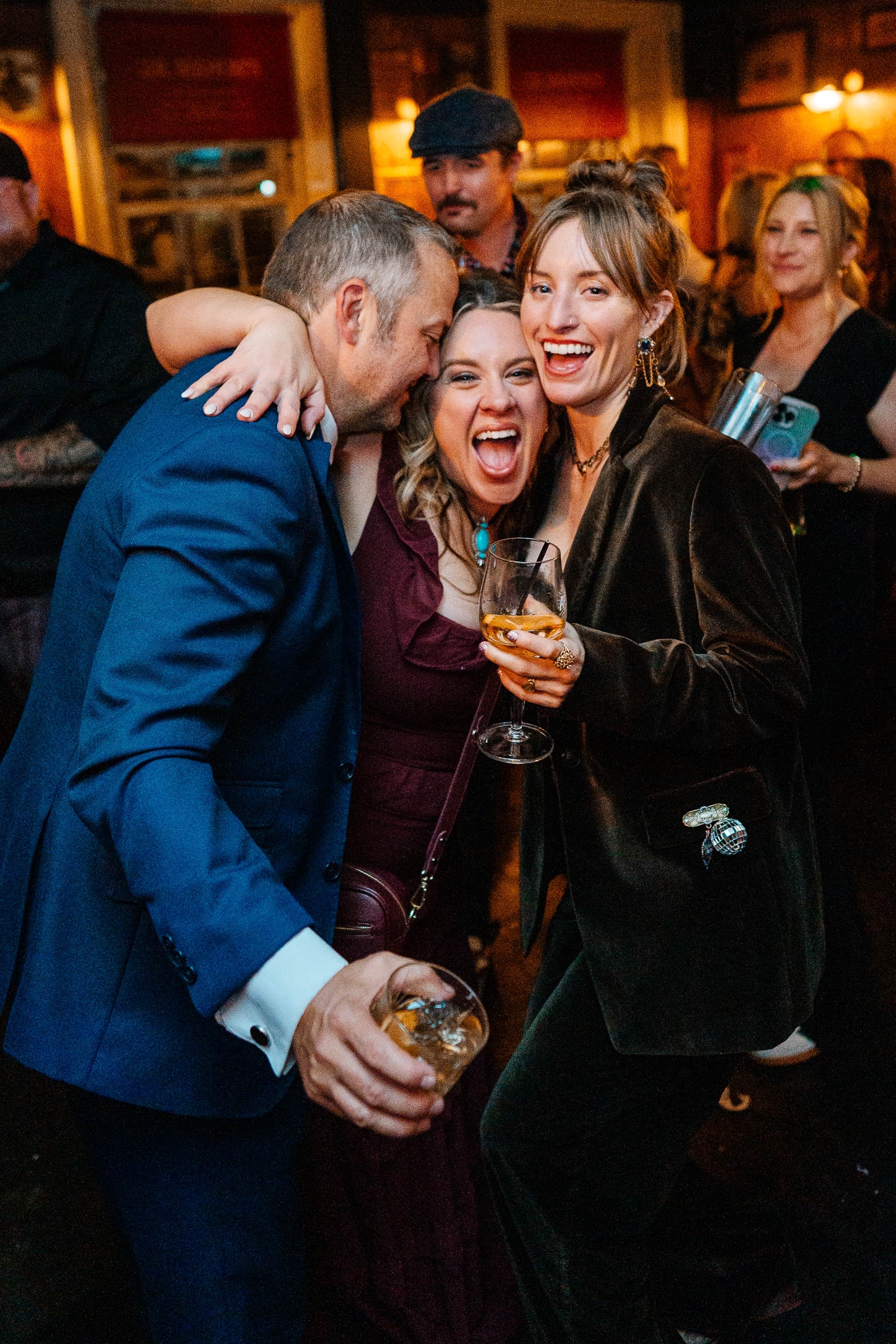 Bride and groom laughing with a wedding guest during their cake cutting celebration at J.R. Mahon's Dublin