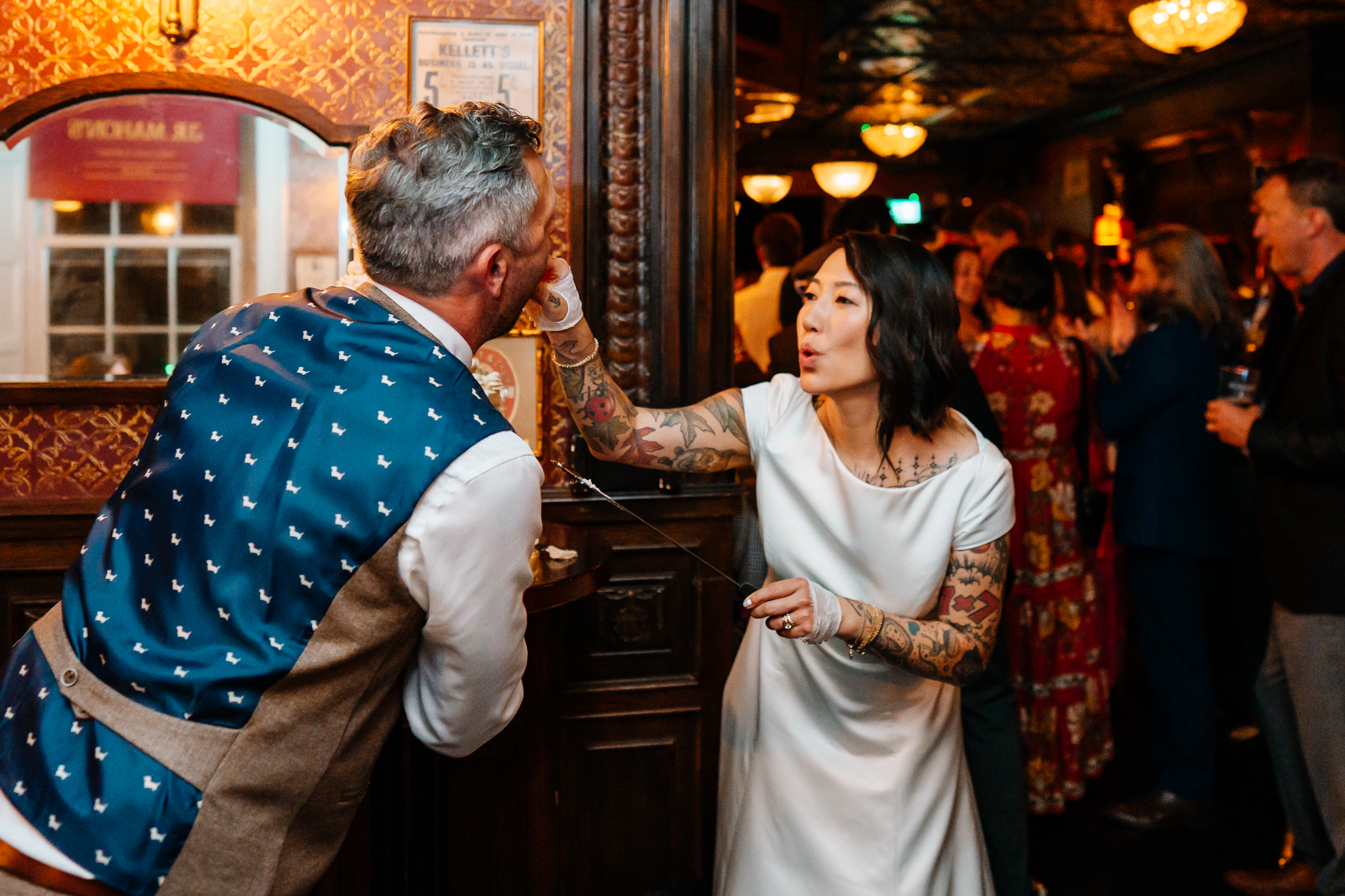 Bride and groom sharing their wedding cake celebration with guests at J.R. Mahon's Dublin