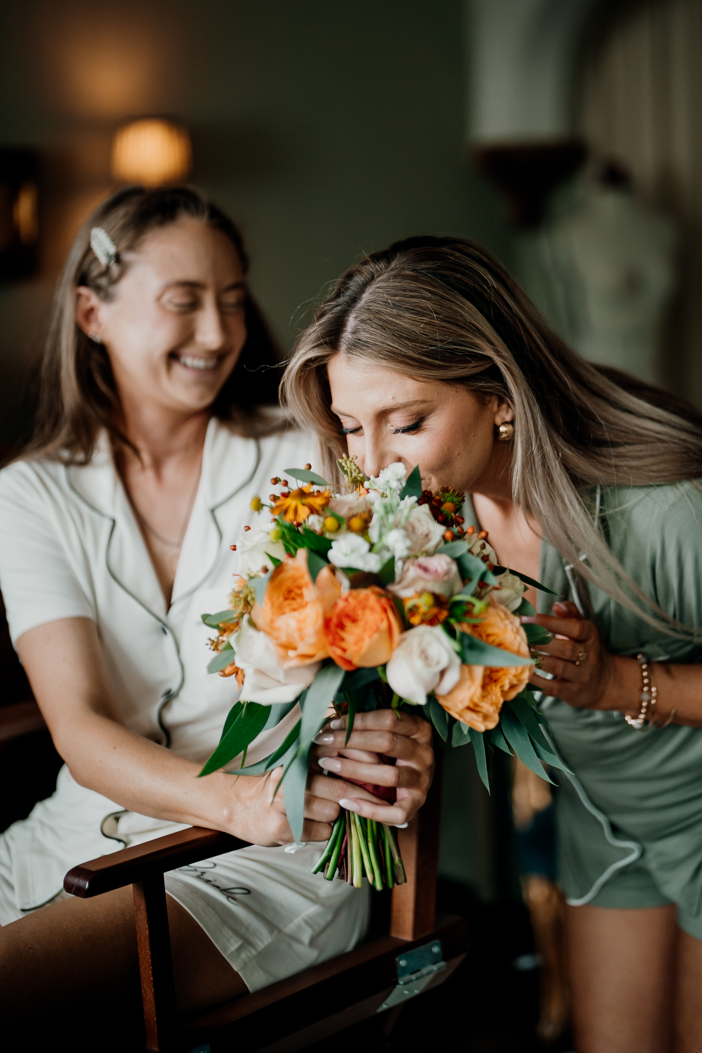 Bride admiring her colourful wedding bouquet during bridal preparations at Markree Castle.