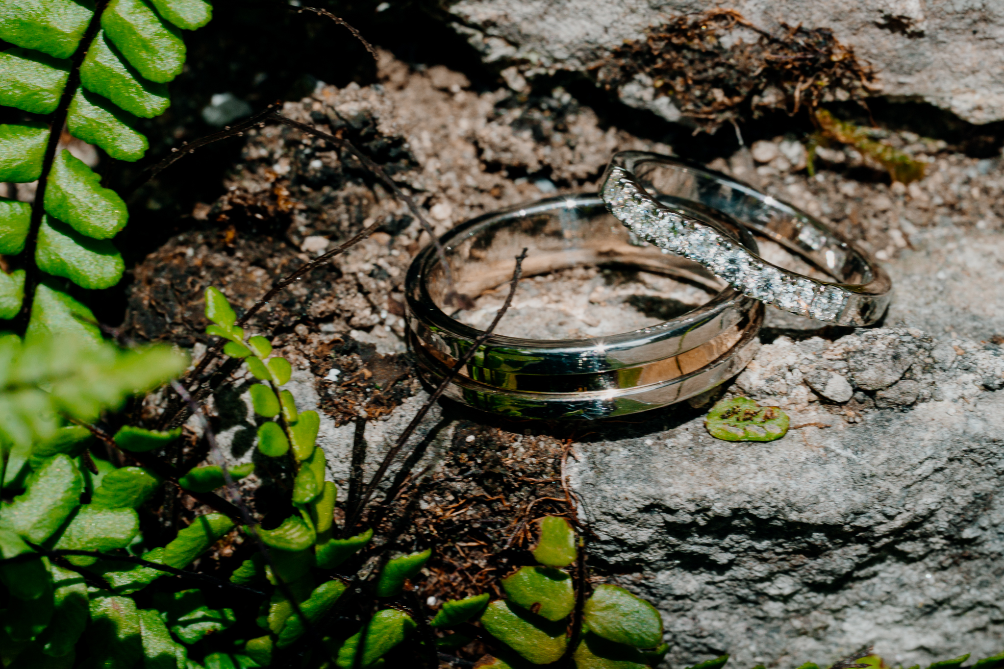 Two wedding rings arranged on a textured stone surface during wedding preparations at Markree Castle.