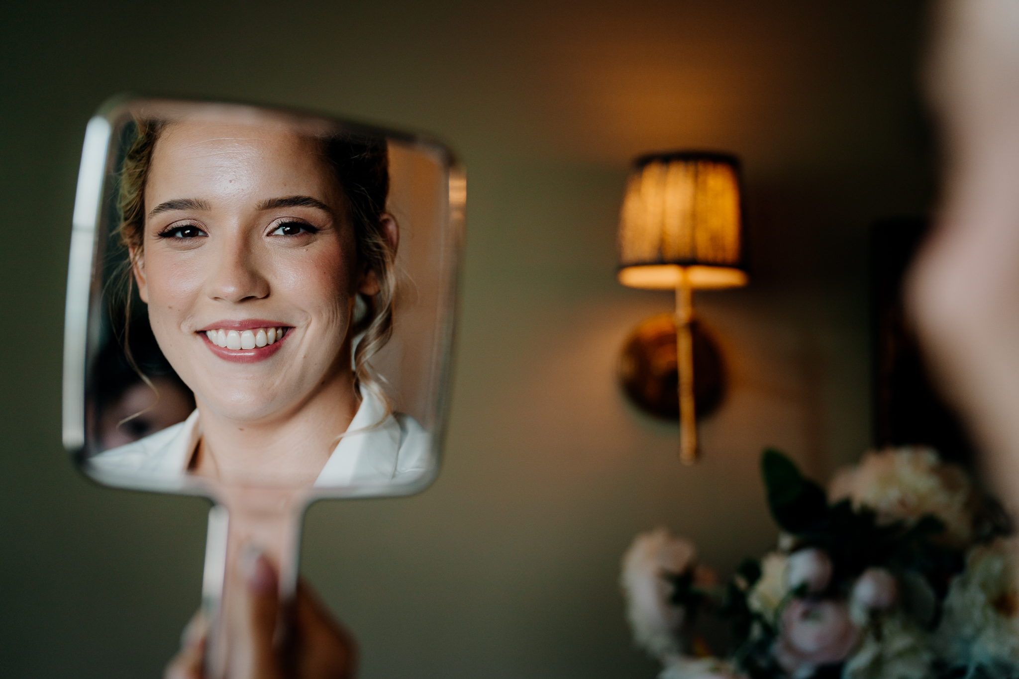 Smiling bride during her wedding morning preparations at Markree Castle, with warm interior lighting behind her.