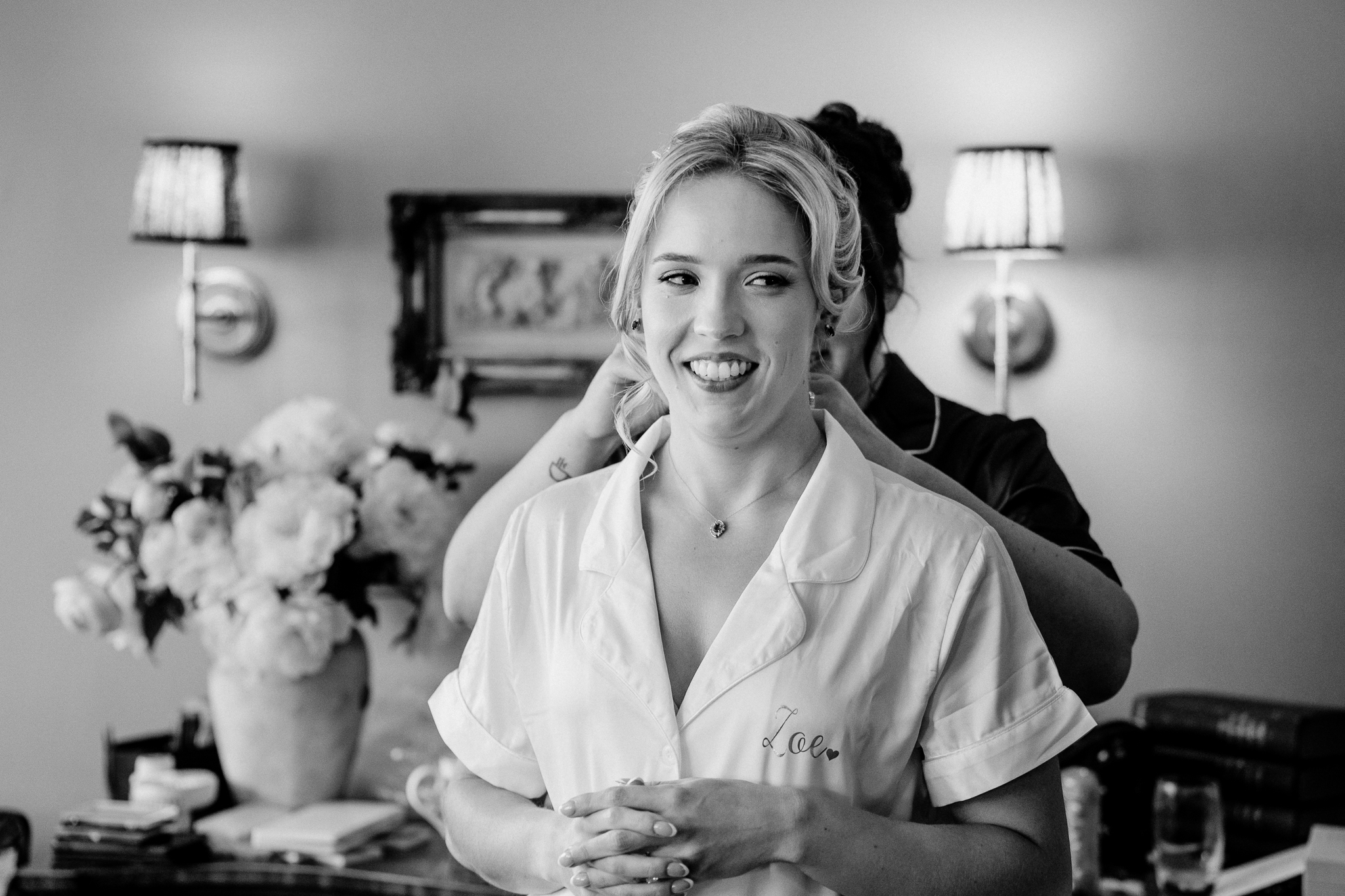 Black and white portrait of a smiling bride during wedding morning preparations in the Butler's Kitchen at Markree Castle.