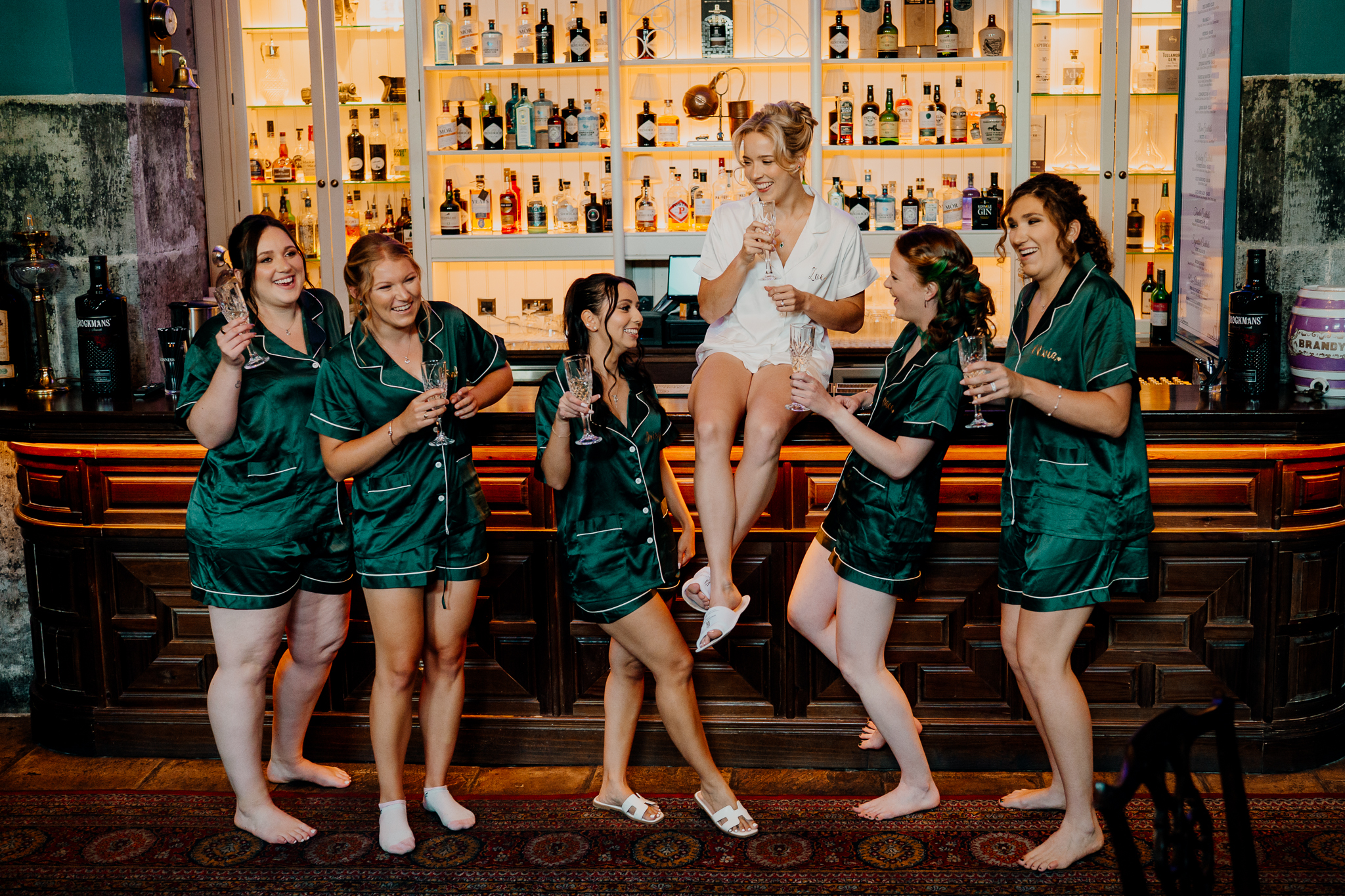 Bride and bridesmaids celebrating with drinks in the Gin Bar at Markree Castle before the wedding ceremony.