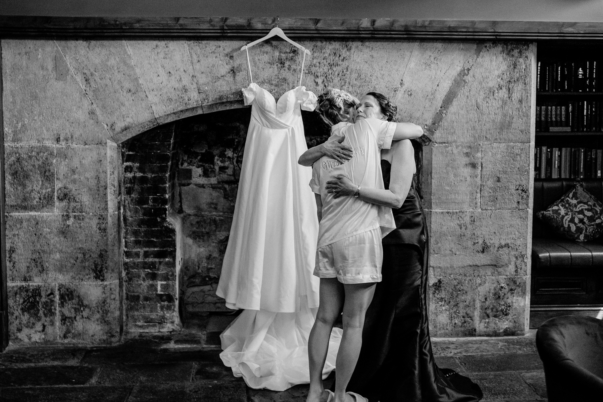 Bridal party arranging a hanging wedding dress in the Gin Bar at Markree Castle before the ceremony.