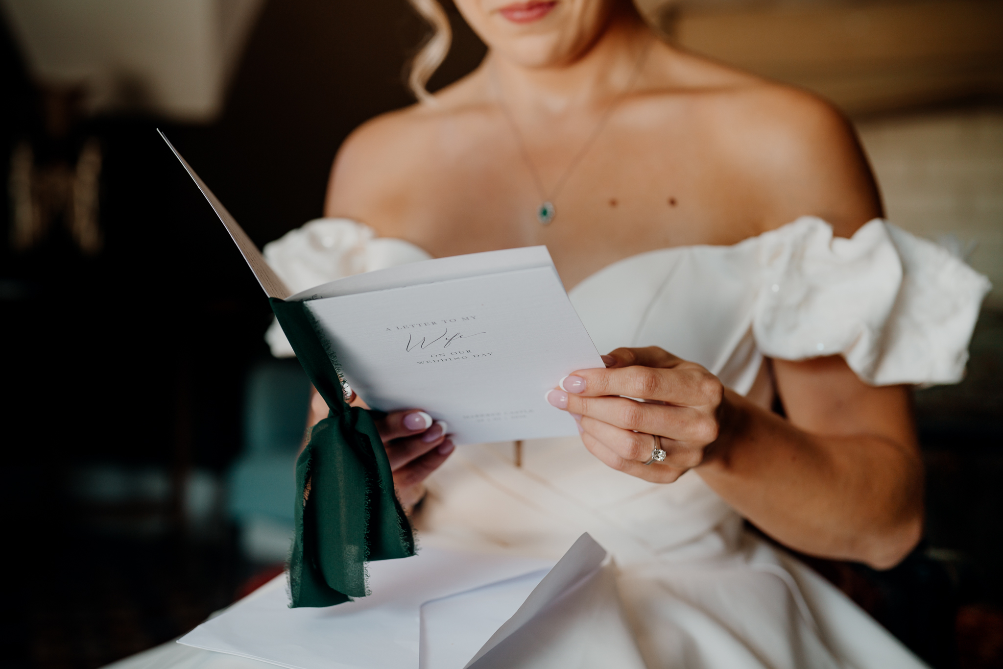 Close-up of a bride reading a letter from her groom during wedding preparations at Markree Castle.