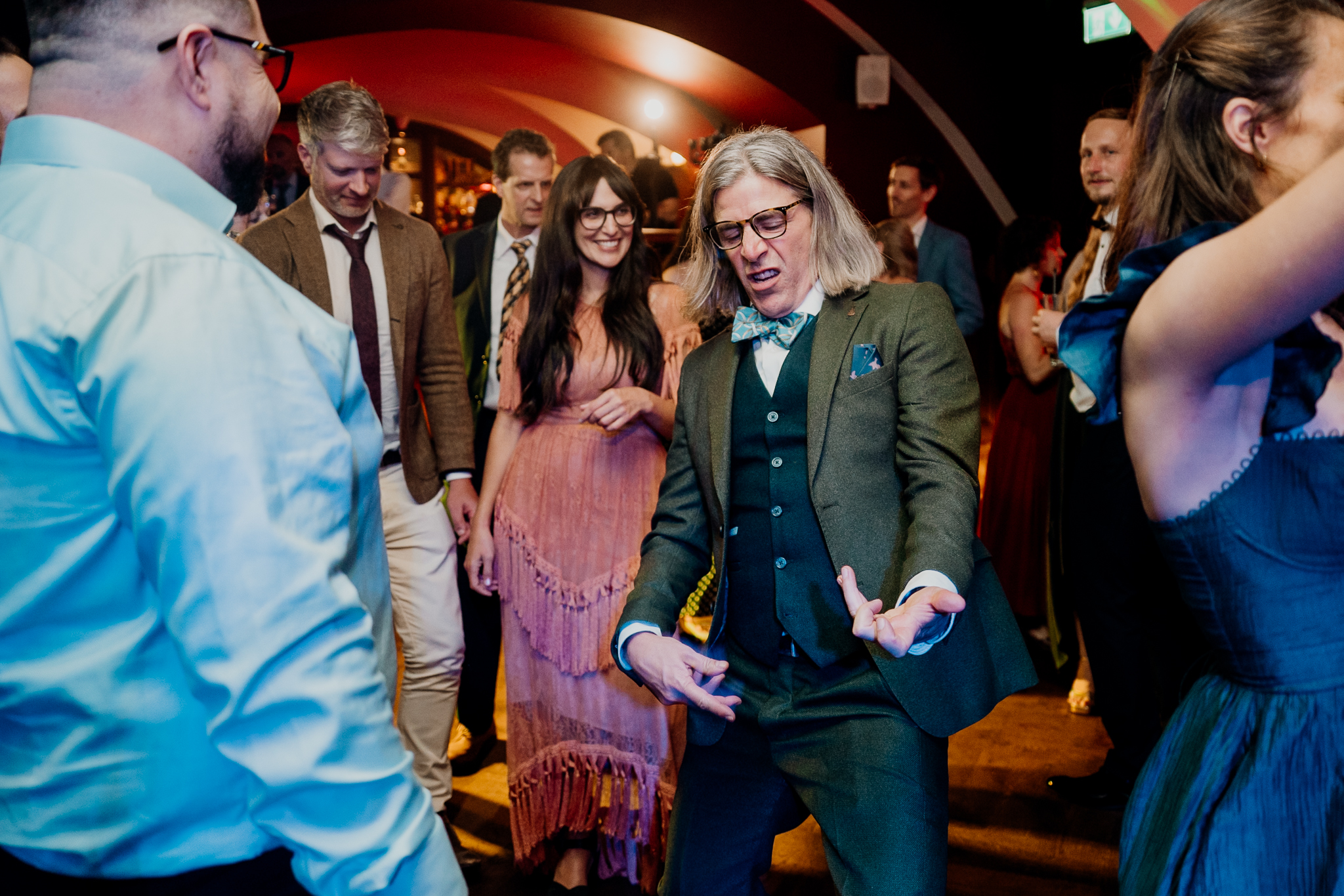 Group of wedding guests smiling and celebrating together on the evening dance floor at Markree Castle.