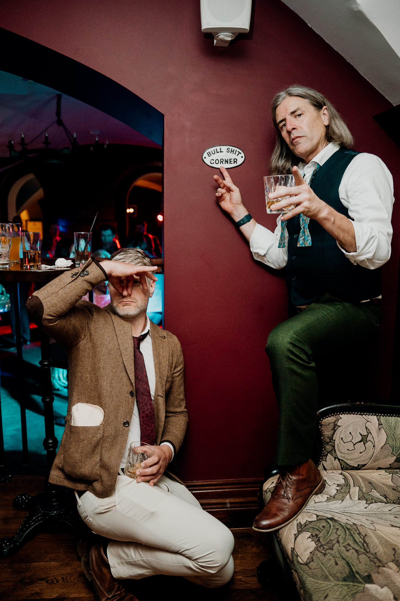 Wedding guest raising a drink while celebrating with friends on the dance floor at Markree Castle.