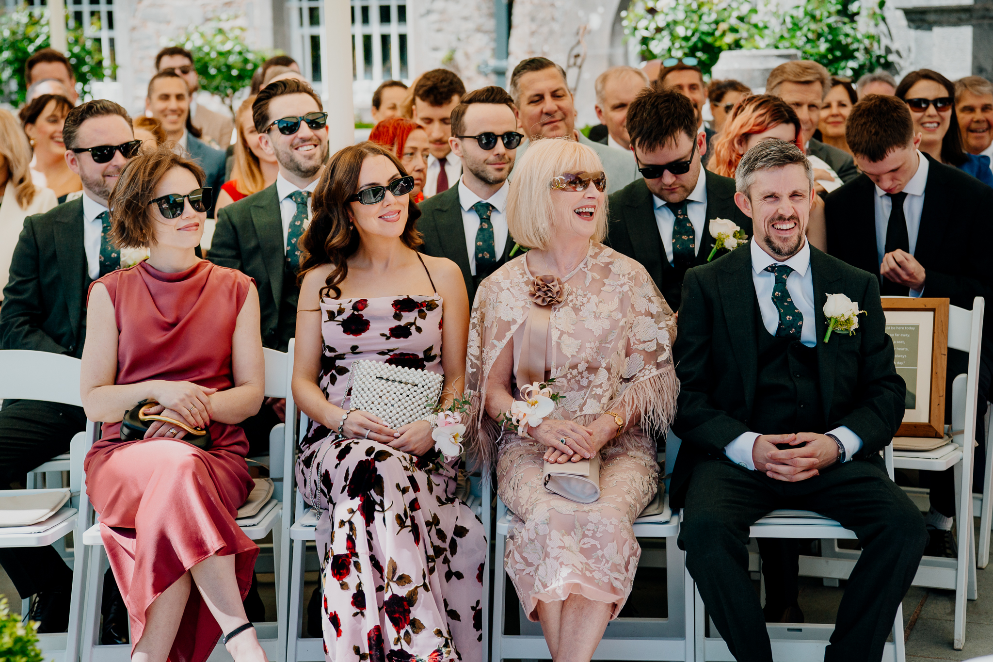 Wedding guests watching an outdoor garden ceremony at Markree Castle, Sligo.