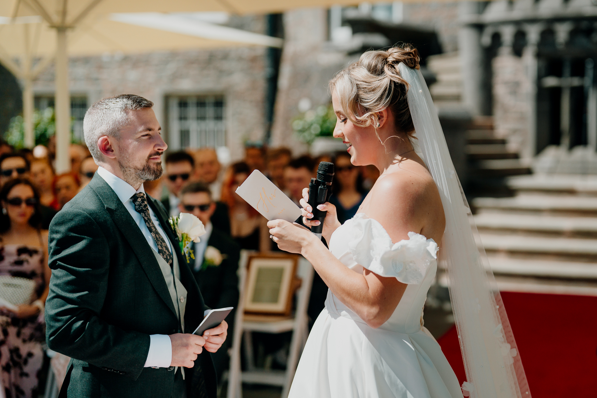 Bride and groom with their celebrant during an outdoor garden wedding ceremony at Markree Castle.