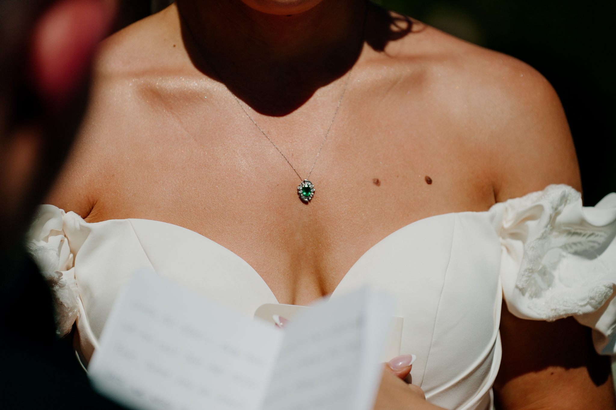 Bride wearing a delicate green pendant necklace with an off-the-shoulder wedding dress at Markree Castle.