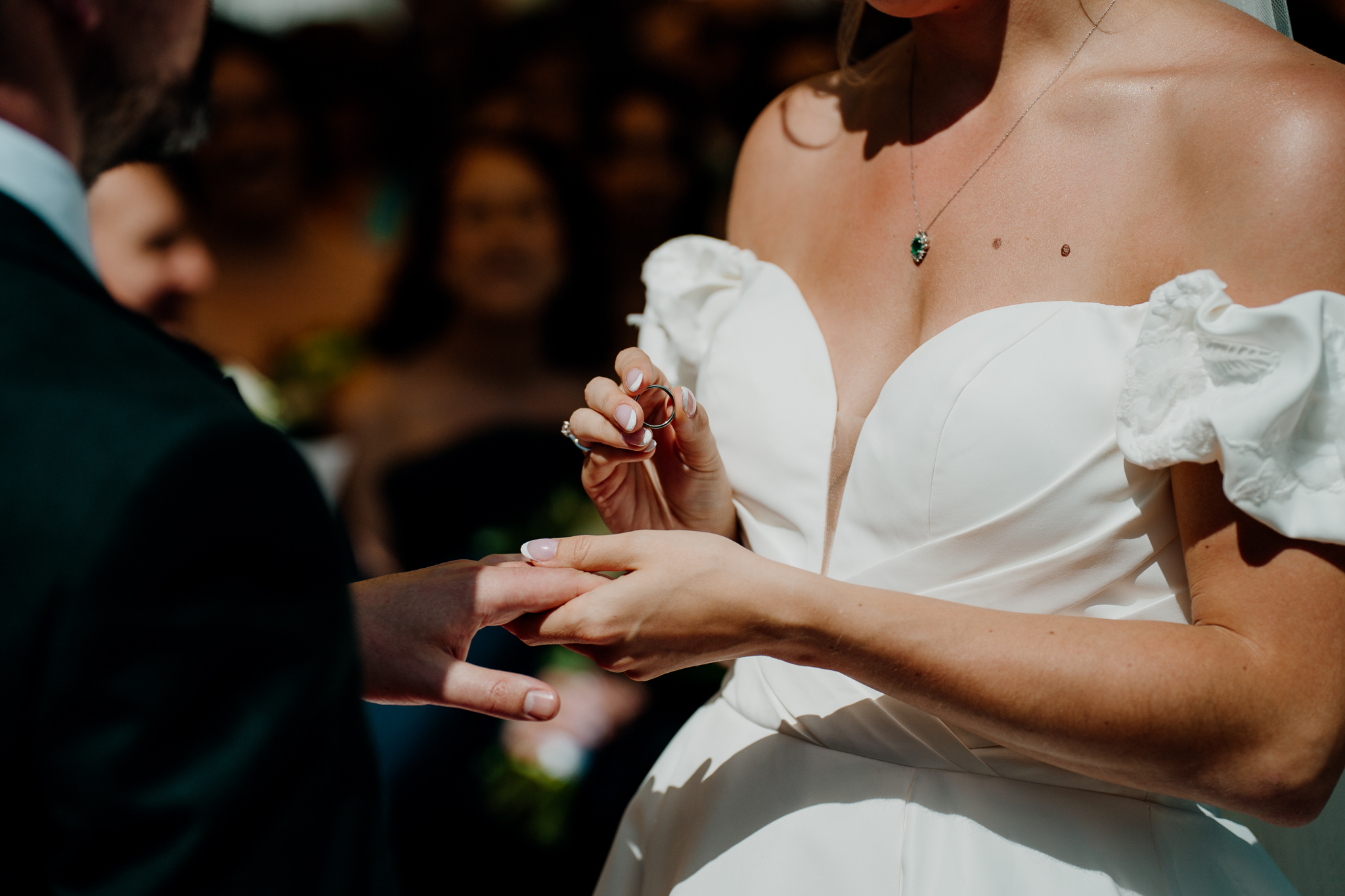 Close-up of bride and groom holding hands during their outdoor wedding ceremony at Markree Castle.