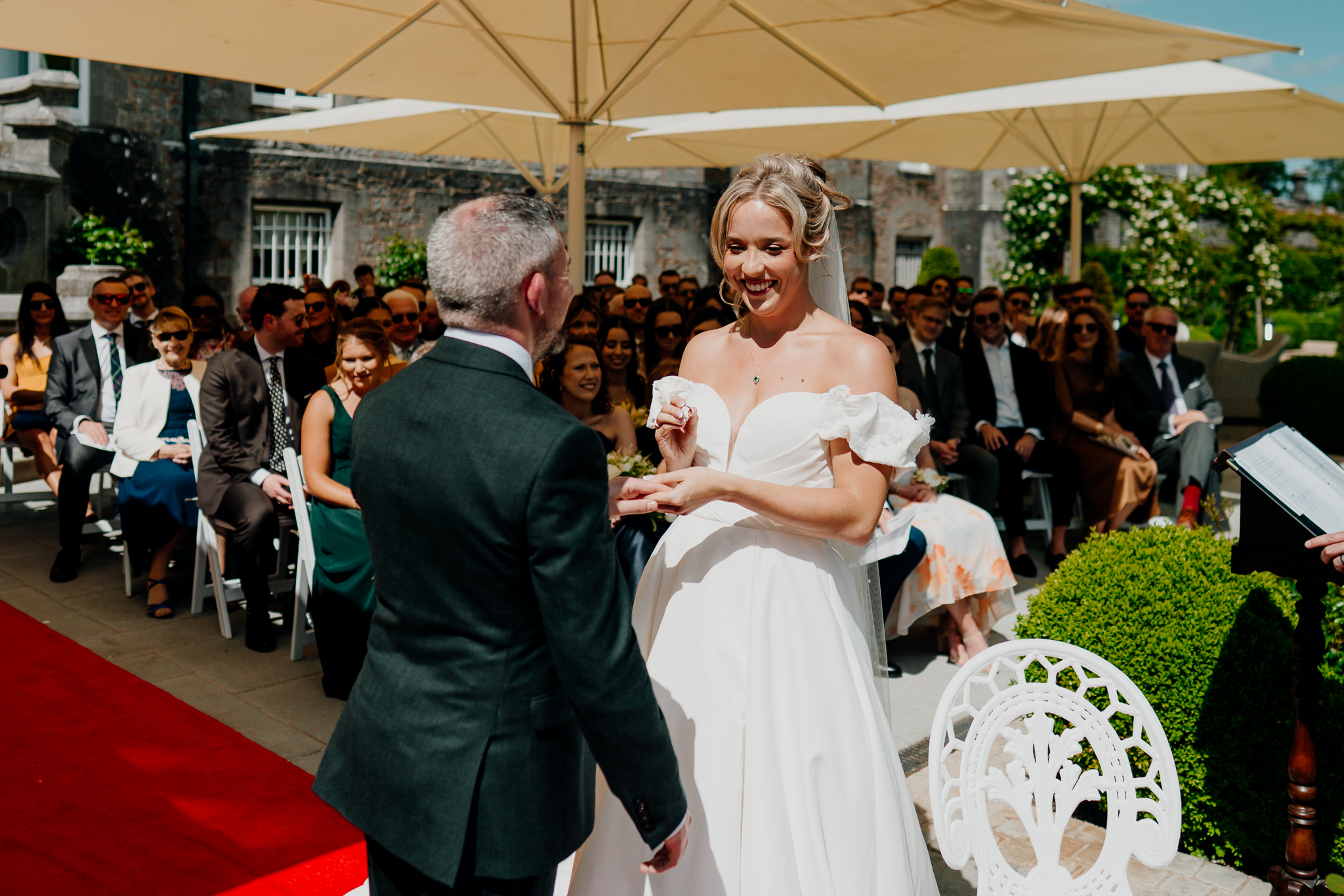 Bride and groom smiling together during their outdoor garden wedding ceremony at Markree Castle, Sligo.