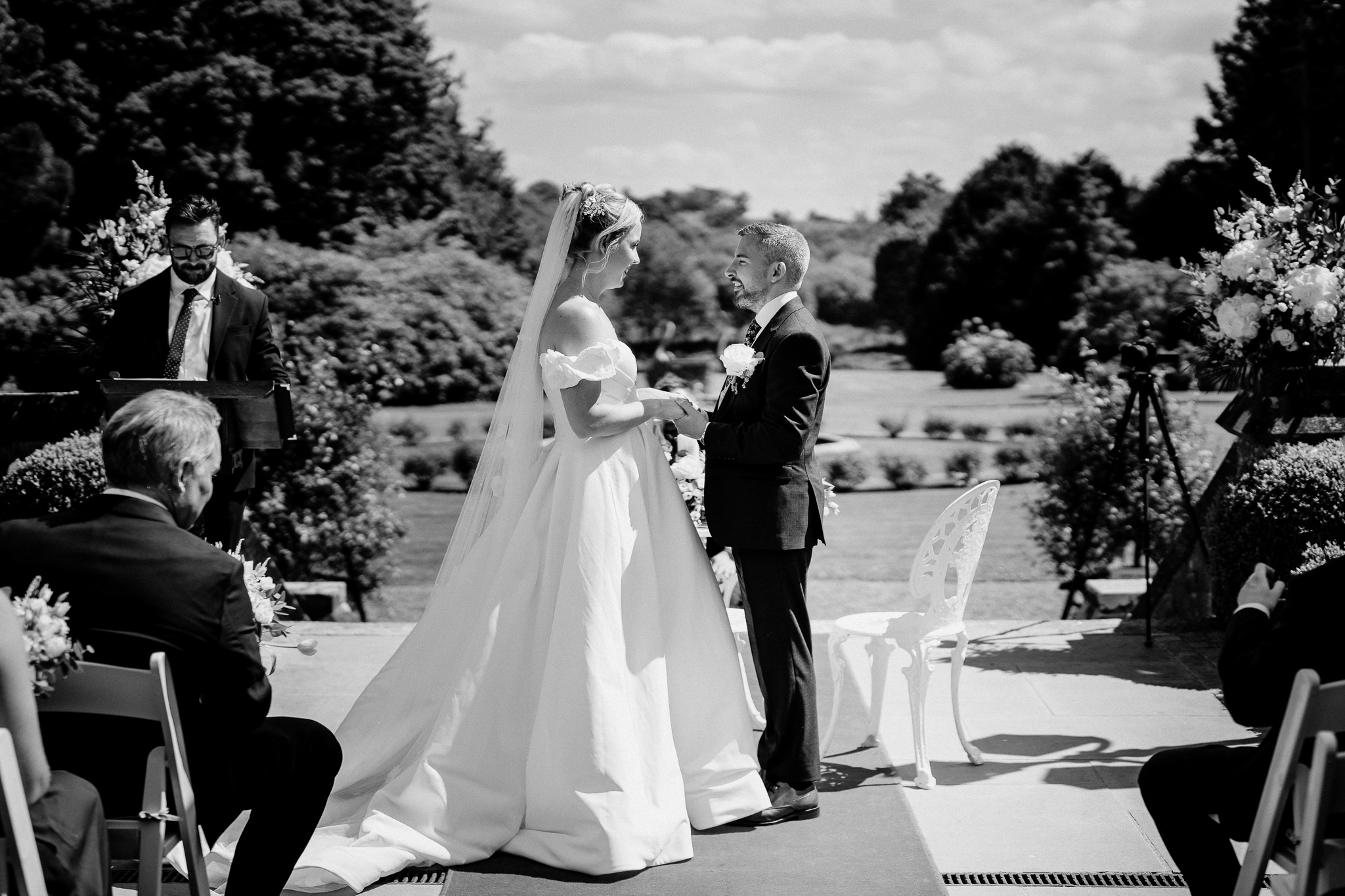 Black and white wide photograph of an outdoor wedding ceremony in the gardens of Markree Castle.