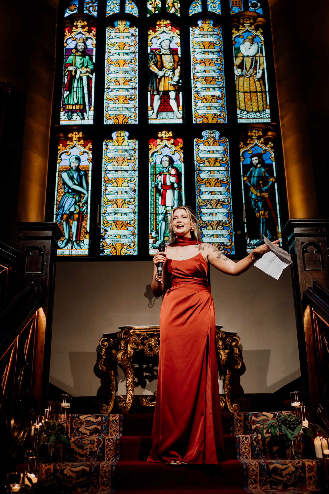 Bride giving a wedding speech beside the stained glass windows on the grand staircase at Markree Castle.