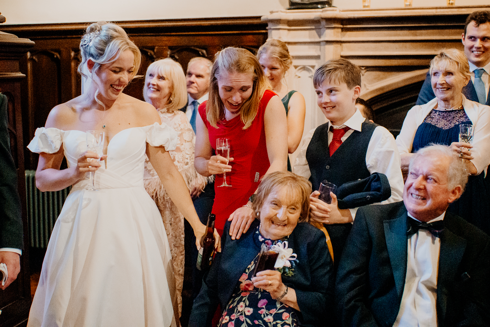 Bride and family members laughing together during wedding speeches beside the grand staircase at Markree Castle.