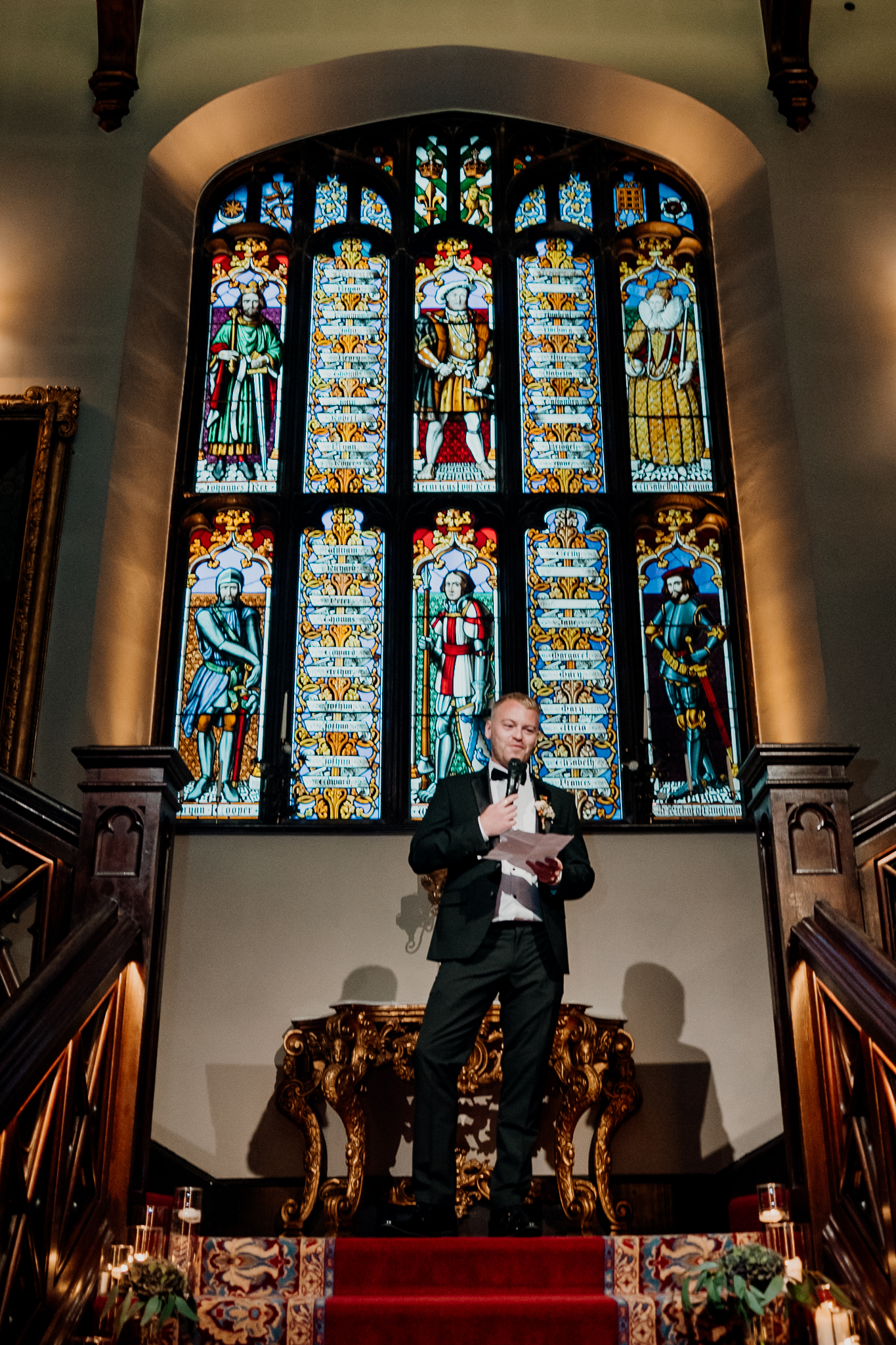 Colourful stained glass windows above the grand staircase at Markree Castle during the wedding speeches.