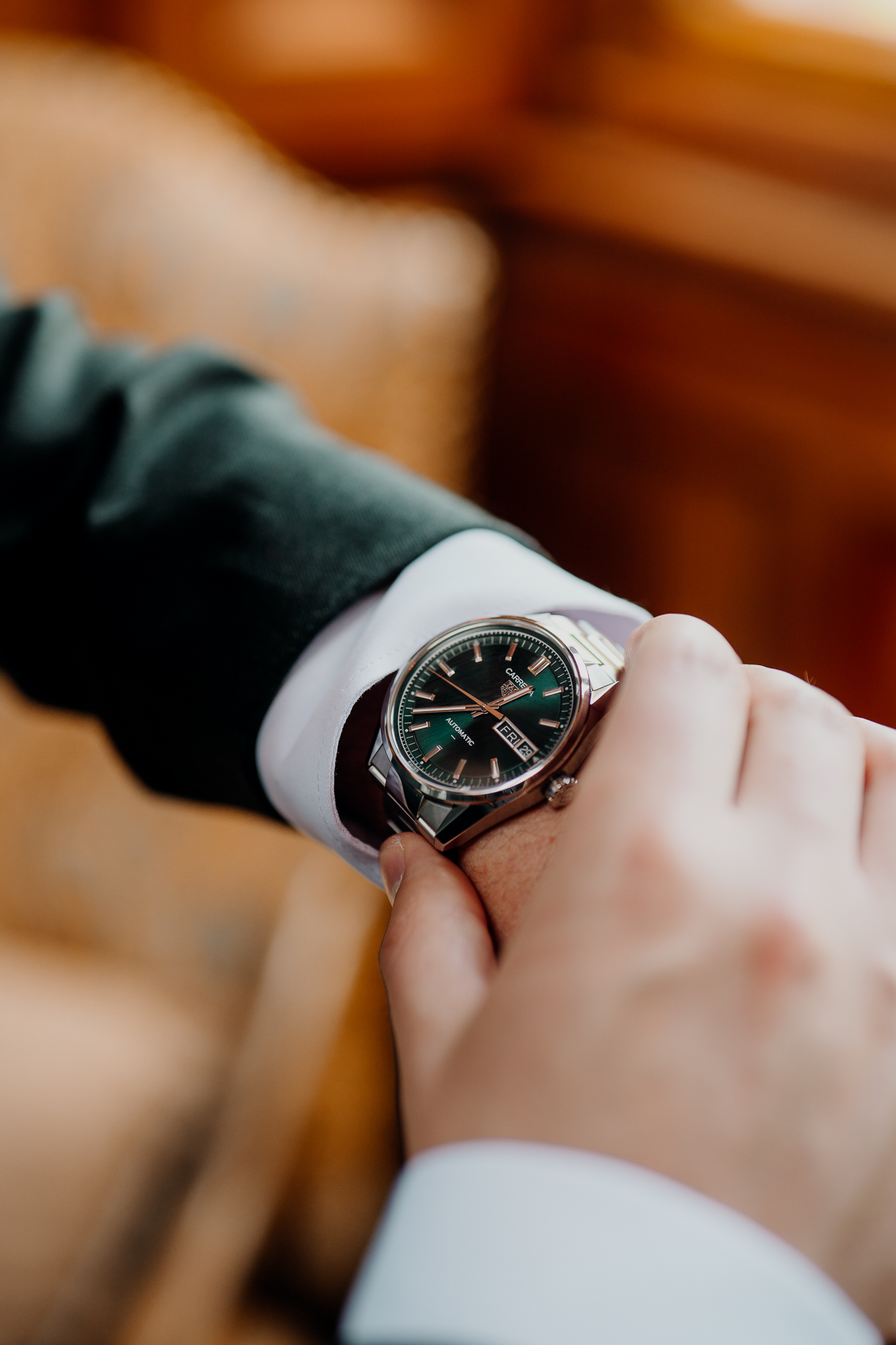 Close-up of a groom's wristwatch and dark green suit during wedding preparations at Markree Castle.
