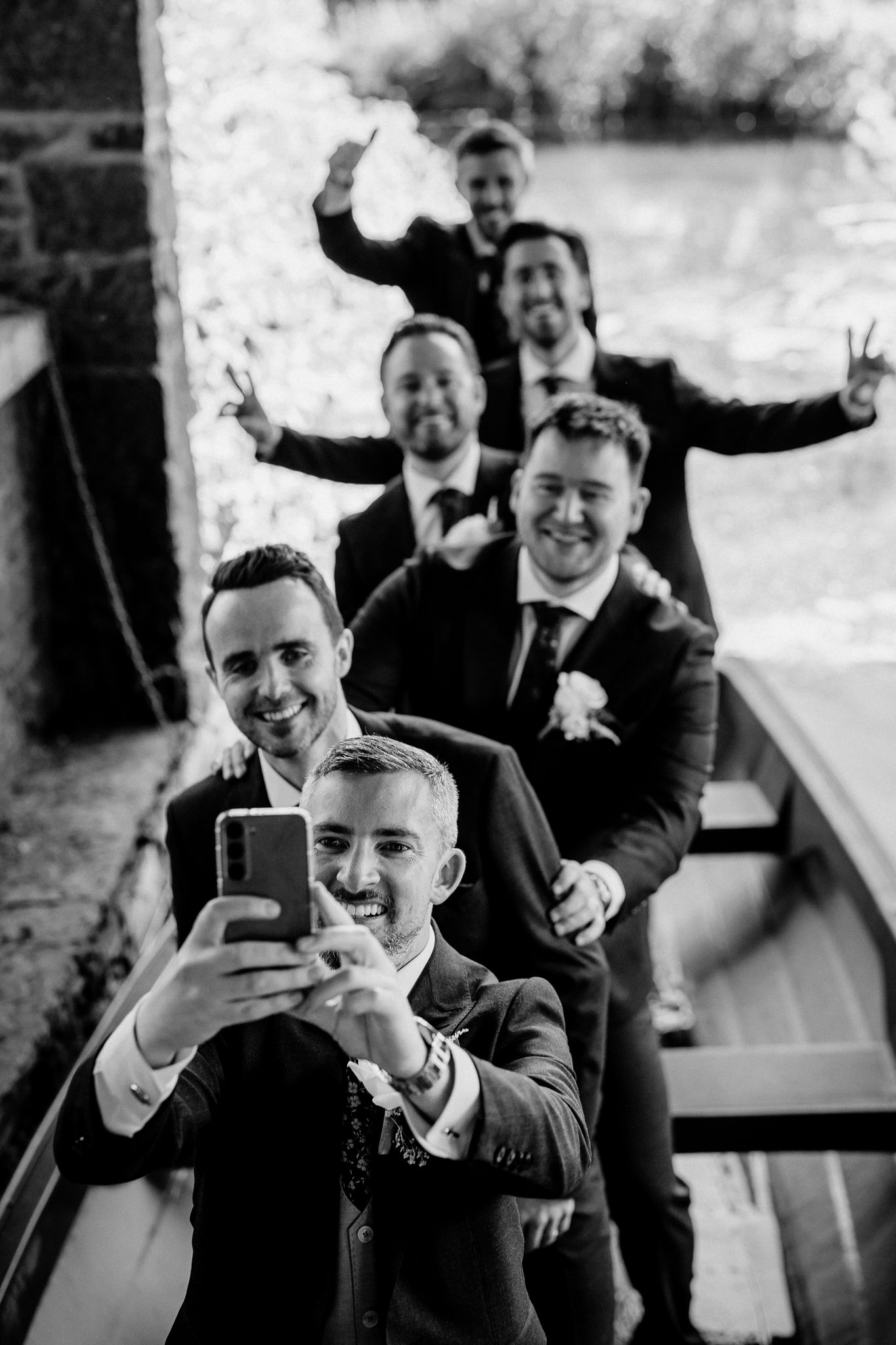 Groom and groomsmen taking a fun group selfie beside the Boathouse at Markree Castle.