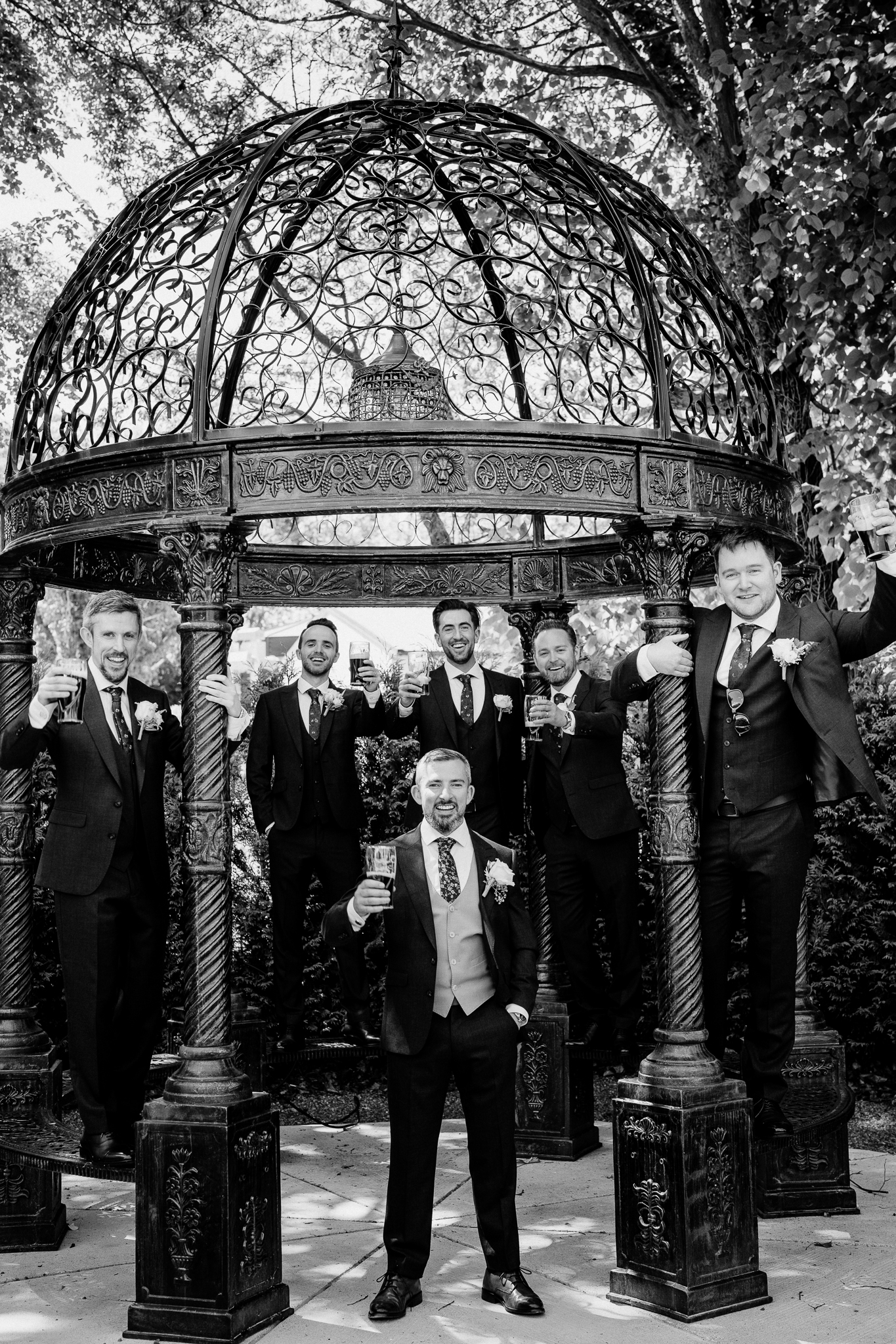 Wide outdoor portrait of groom and groomsmen on the lawn in front of Markree Castle in Sligo.