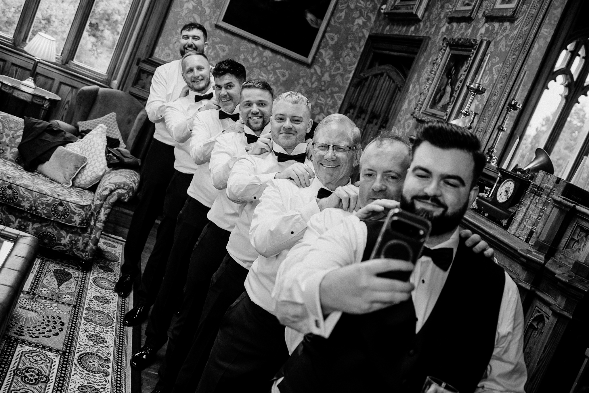 Black and white portrait of the groom with his groomsmen during wedding preparations at Markree Castle.
