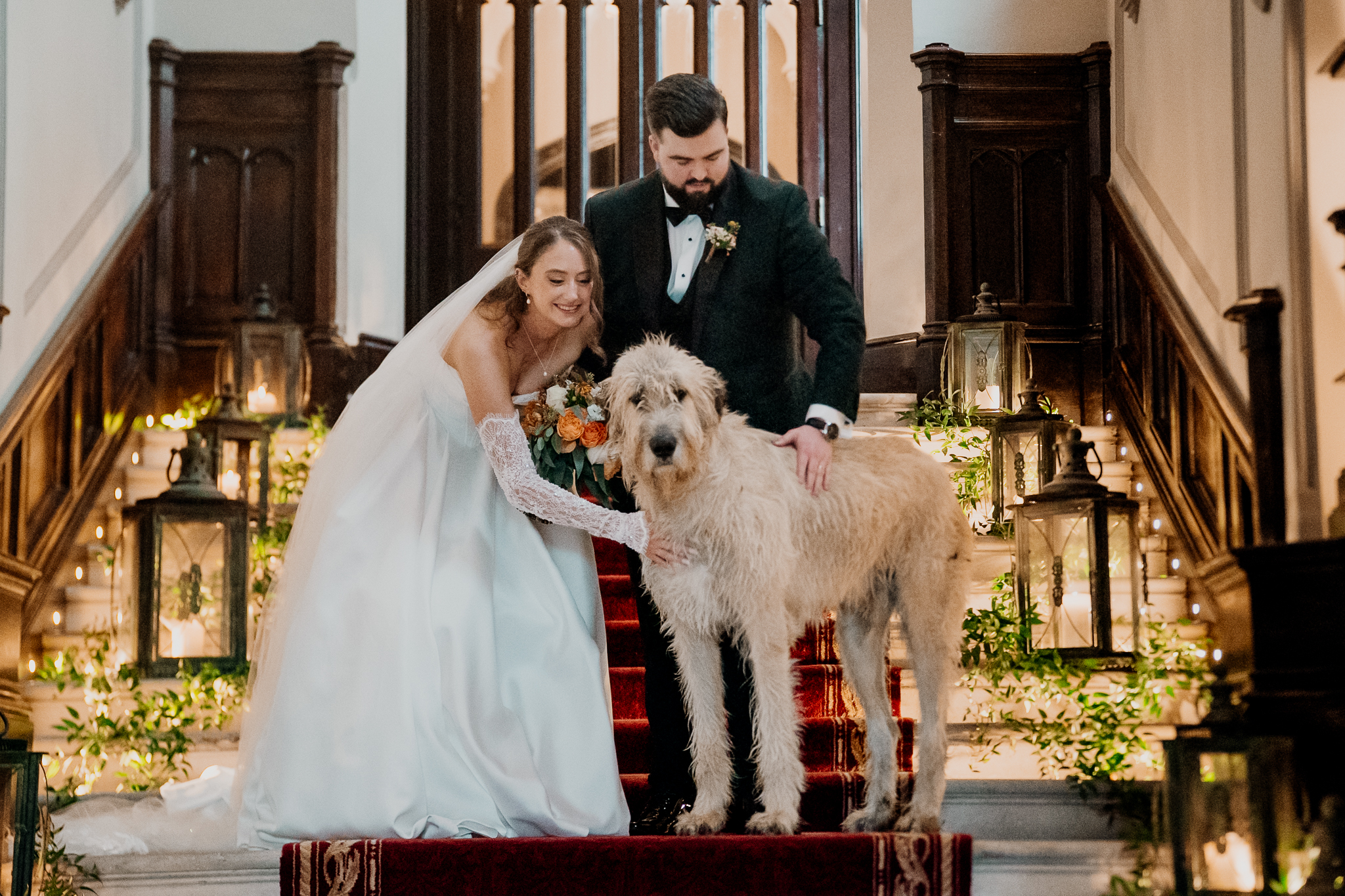 Bride and groom posing for a wedding portrait with Fion beside a wooden staircase inside Markree Castle.