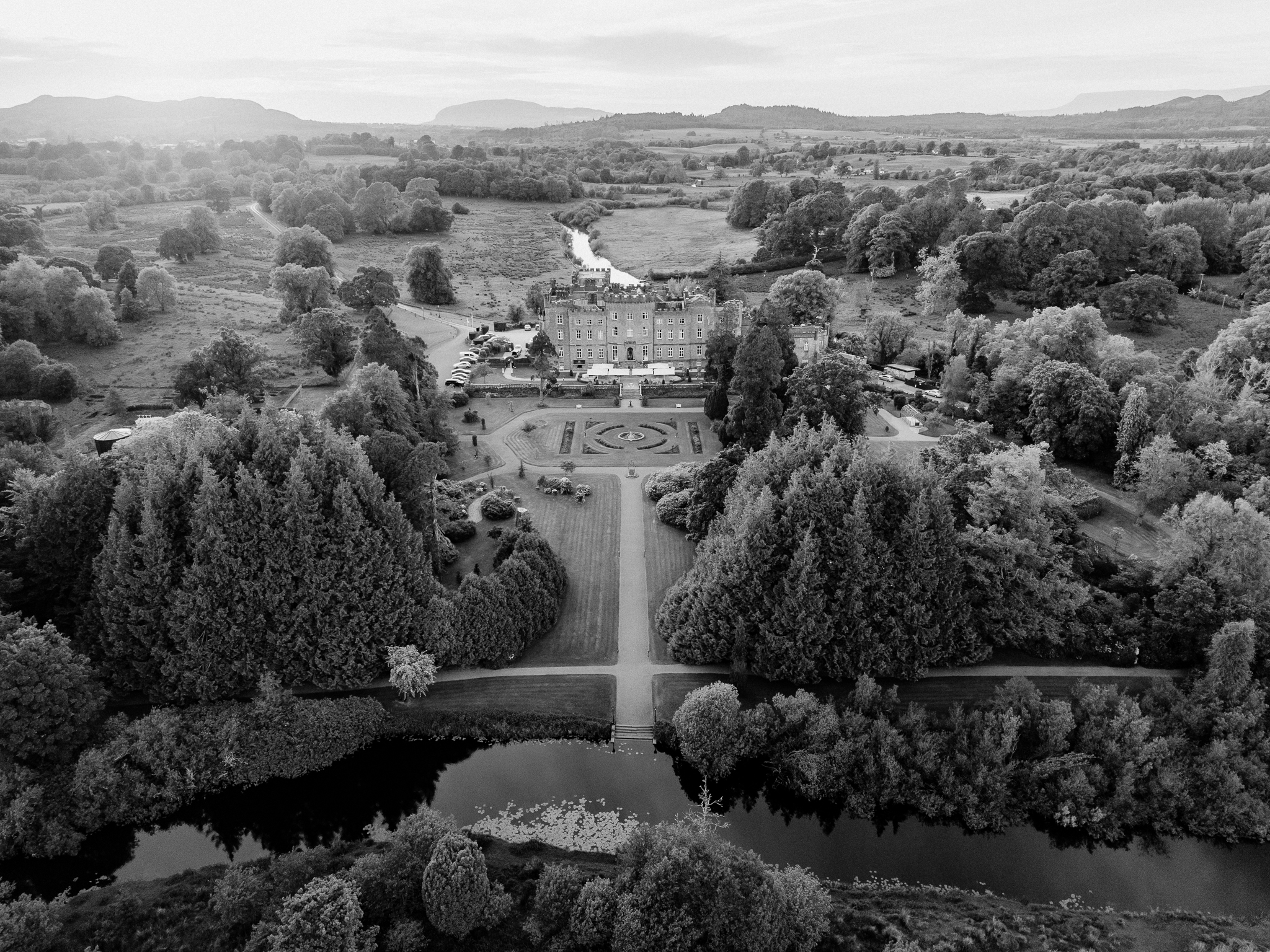 Black and white aerial photograph of Markree Castle, its formal gardens and surrounding wooded landscape in County Sligo, Ireland.