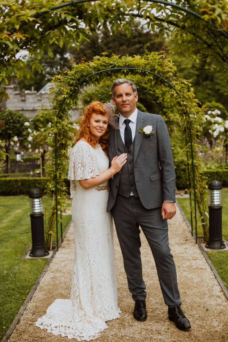 Bride and groom posing together on a garden pathway during their Markree Castle wedding in Sligo, Ireland