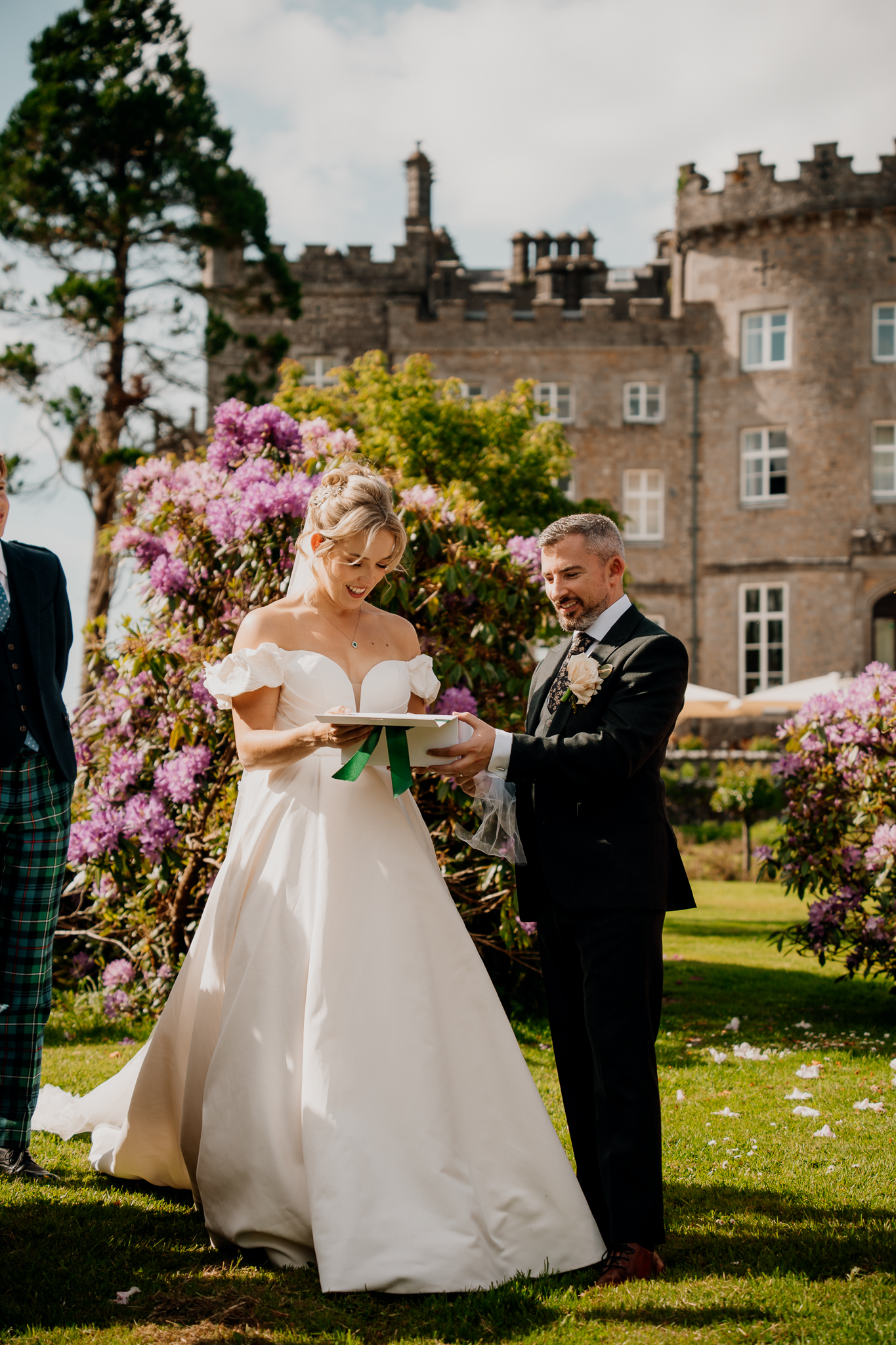 Black and white candid photograph of wedding guests chatting in the gardens of Markree Castle, County Sligo.