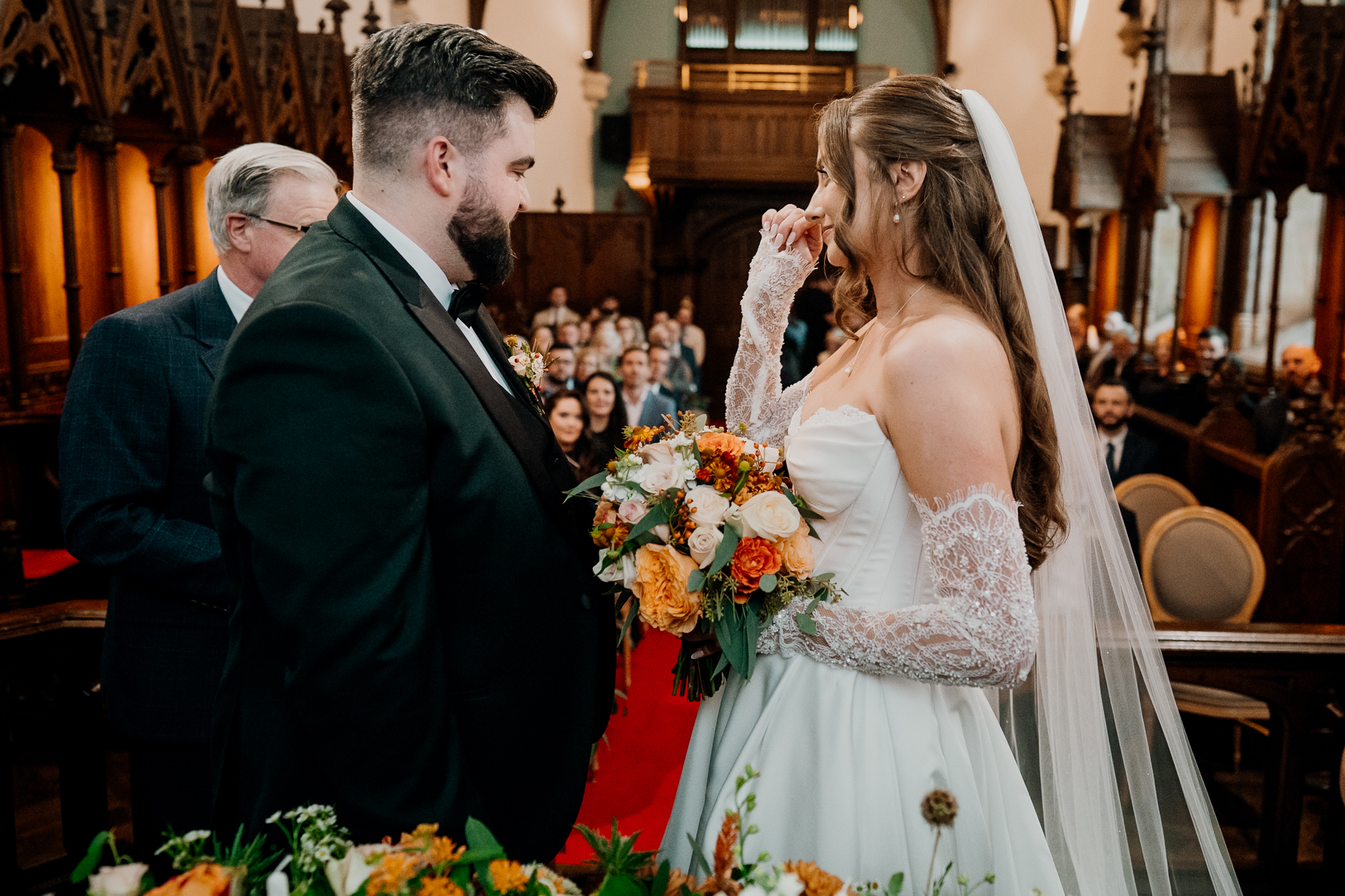 Bride and groom smiling at each other during their wedding ceremony inside Markree Castle Chapel.
