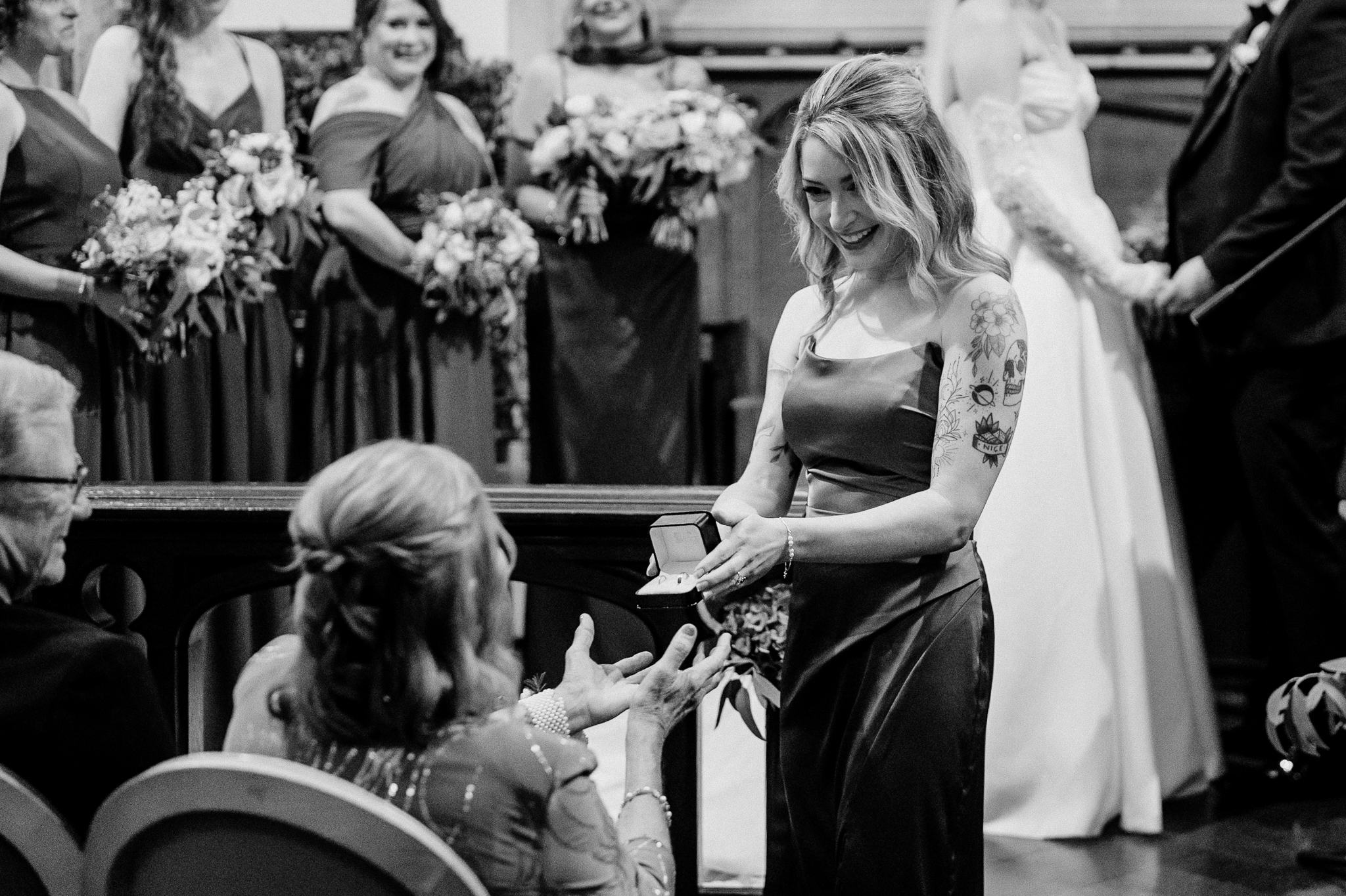Black and white photograph of the bride smiling during her wedding ceremony in Markree Castle Chapel.