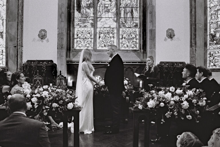 Black and white 35mm film photograph of a wedding ceremony inside the chapel at Markree Castle, County Sligo, Ireland.