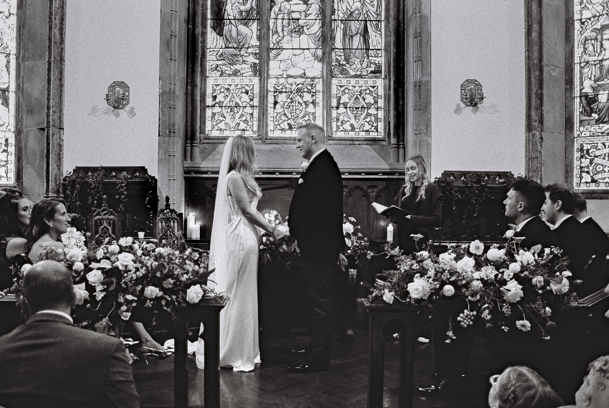 Black and white 35mm film photograph of a wedding ceremony inside the chapel at Markree Castle, County Sligo, Ireland.