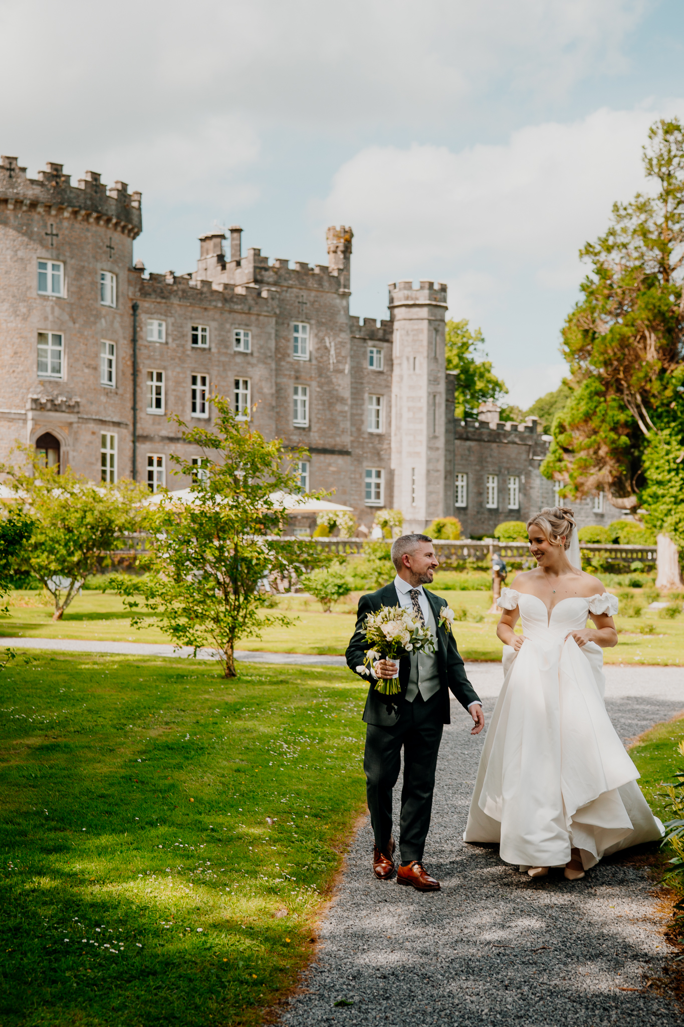 Zoe and Mark during their outdoor wedding portrait session with the historic Markree Castle facade behind them in County Sligo.
