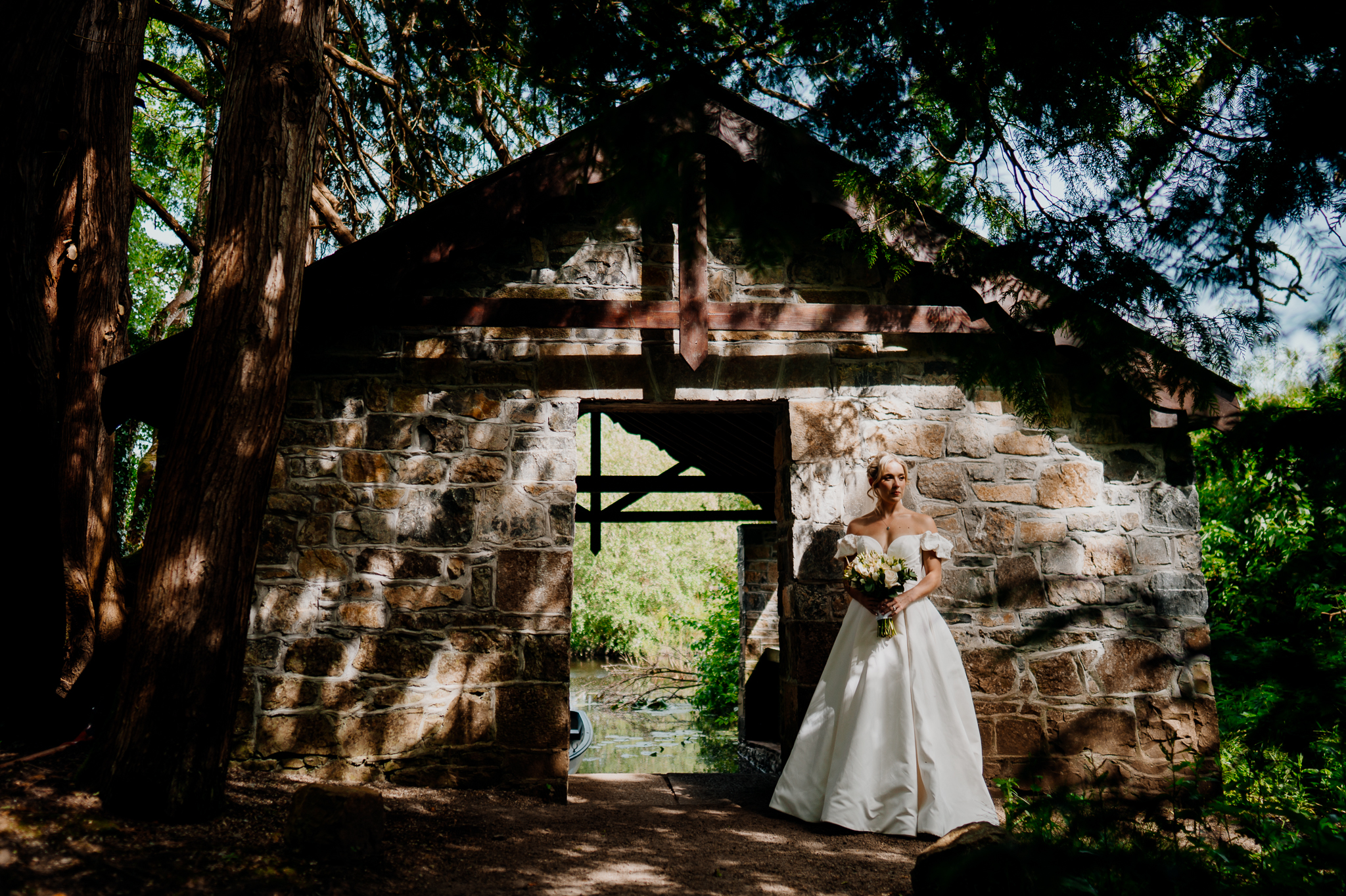 Historic stone Boathouse surrounded by woodland trees at Markree Castle wedding venue in County Sligo, Ireland.