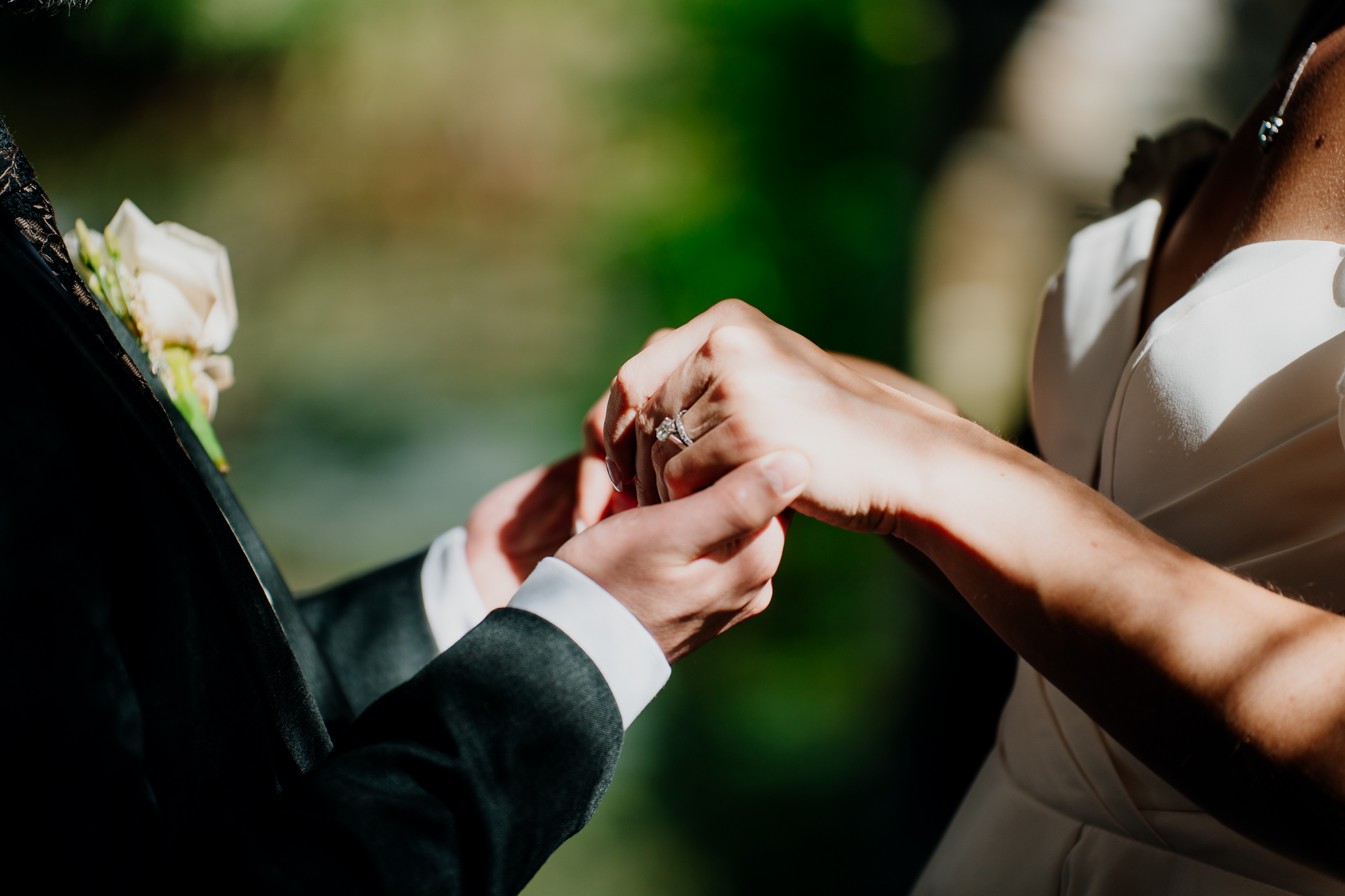 Close-up of a wedding ring being placed on a finger during a romantic woodland portrait session at Markree Castle.
