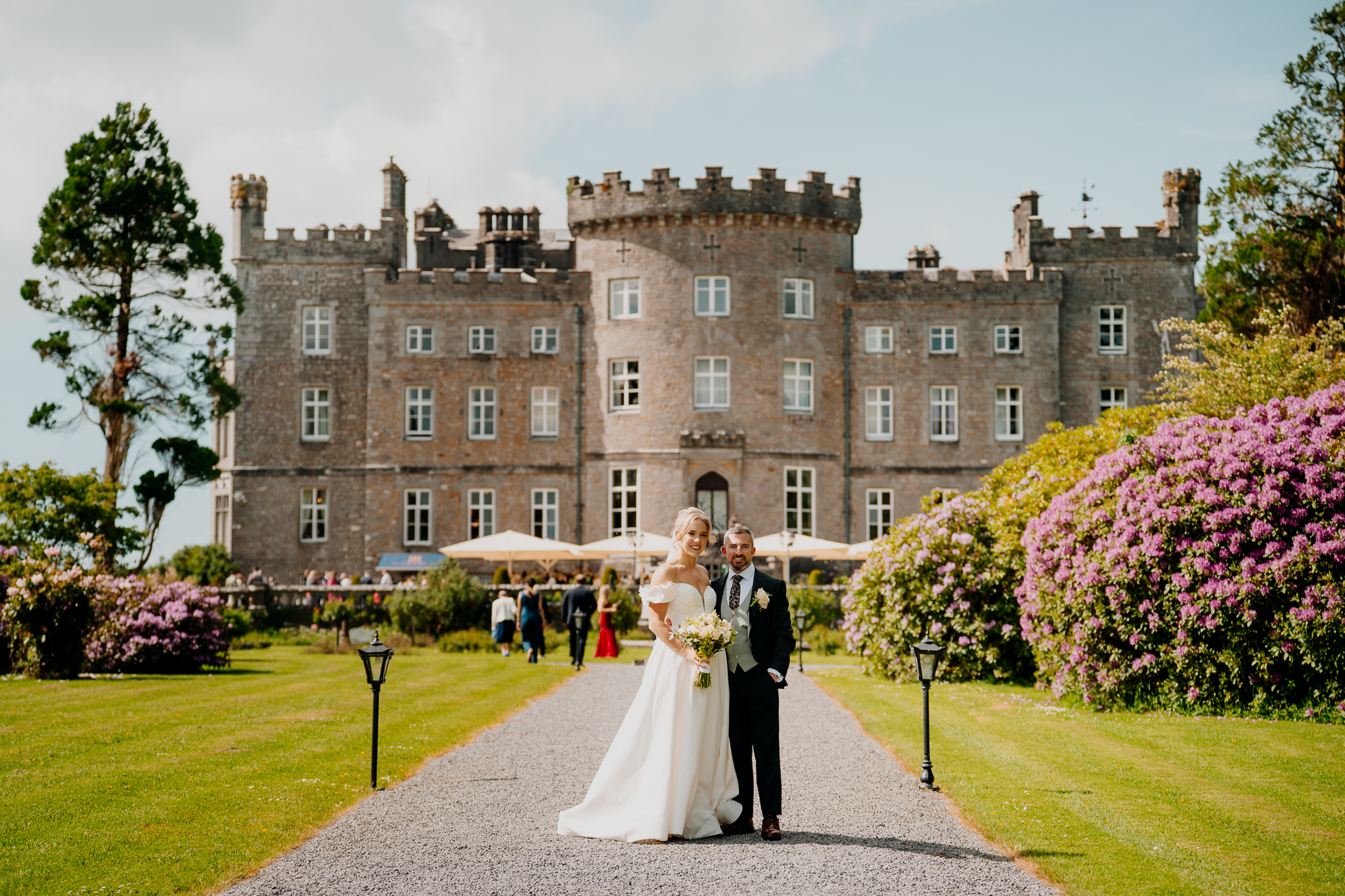 Bride and groom photographed in the gardens in front of the historic Markree Castle facade in County Sligo, Ireland.