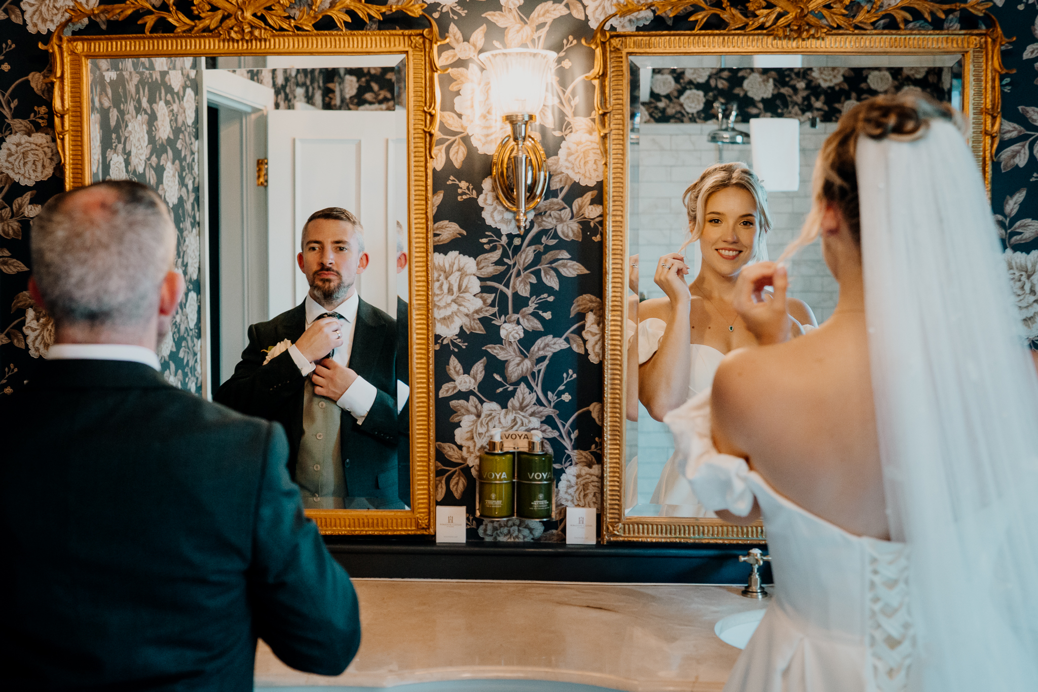 Bride Zoe and groom Mark reflected in ornate mirrors inside the Bridal Suite at Markree Castle.