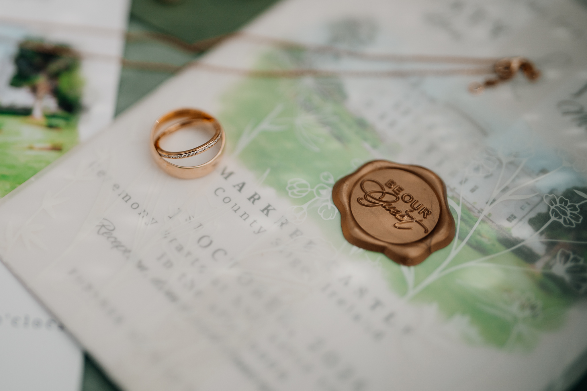 Wedding invitation with gold wedding rings and a wax seal, photographed at Markree Castle.