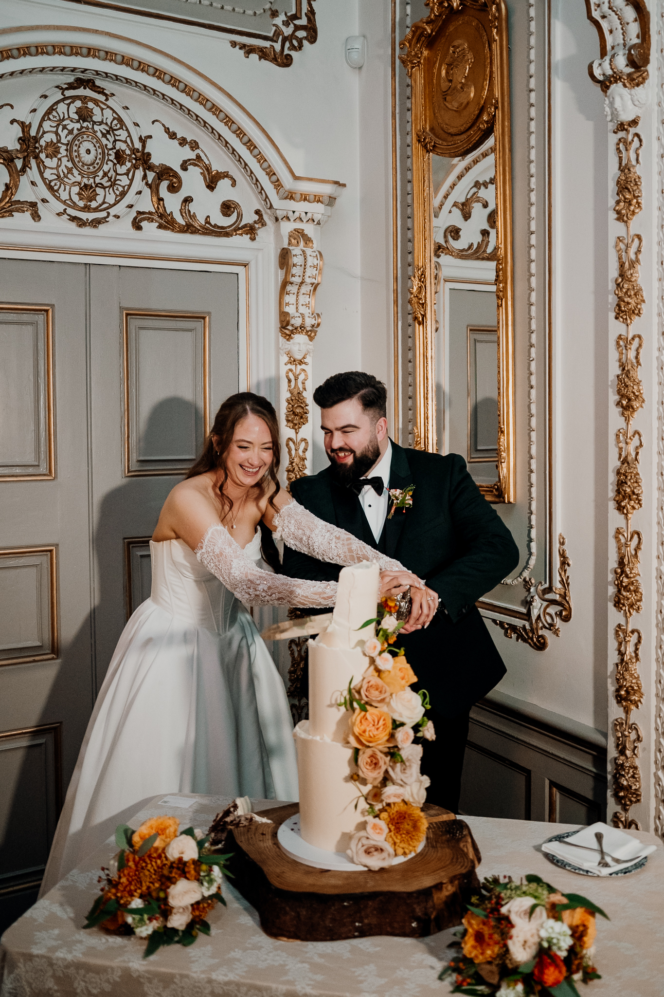 Bride and groom cutting their wedding cake together in an ornate room at Markree Castle, Sligo.