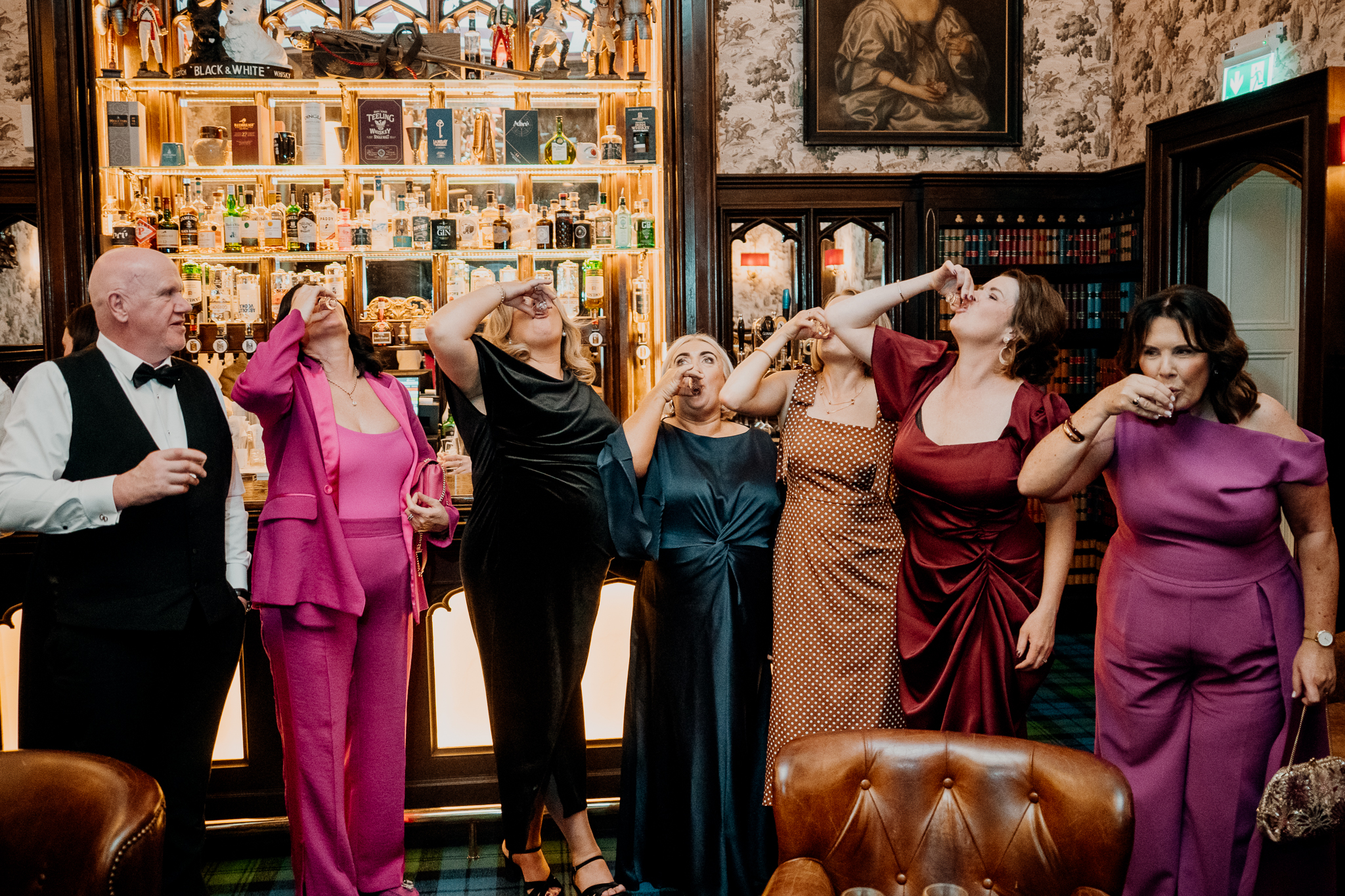 Female wedding guests laughing and celebrating together inside Markree Castle during the evening reception.