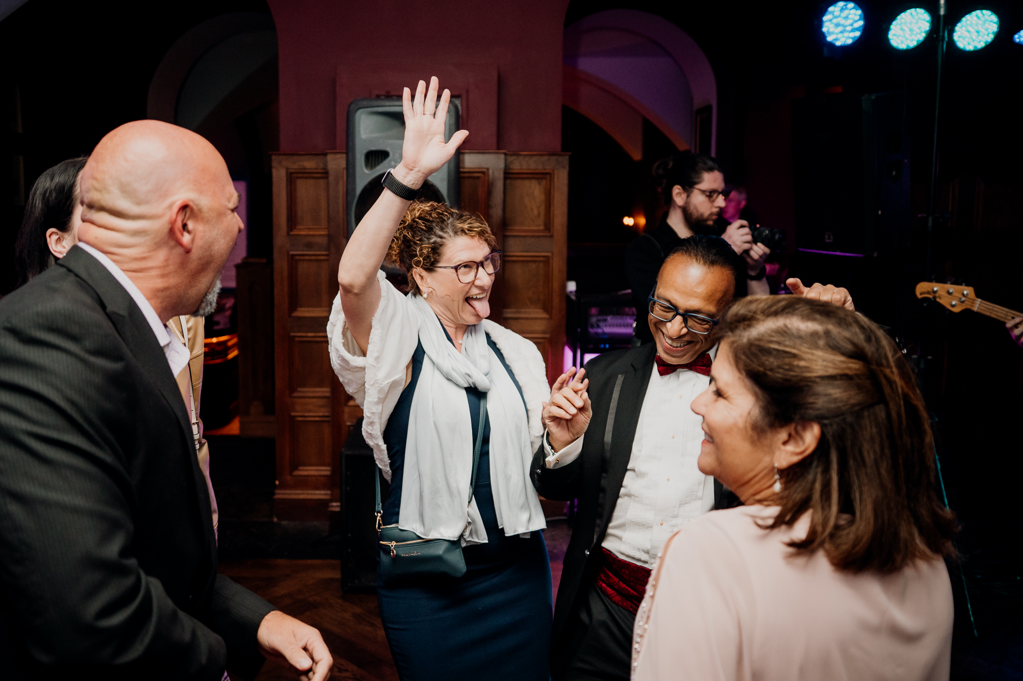 Wedding guests laughing, dancing and raising their hands during the evening reception at Markree Castle, County Sligo.